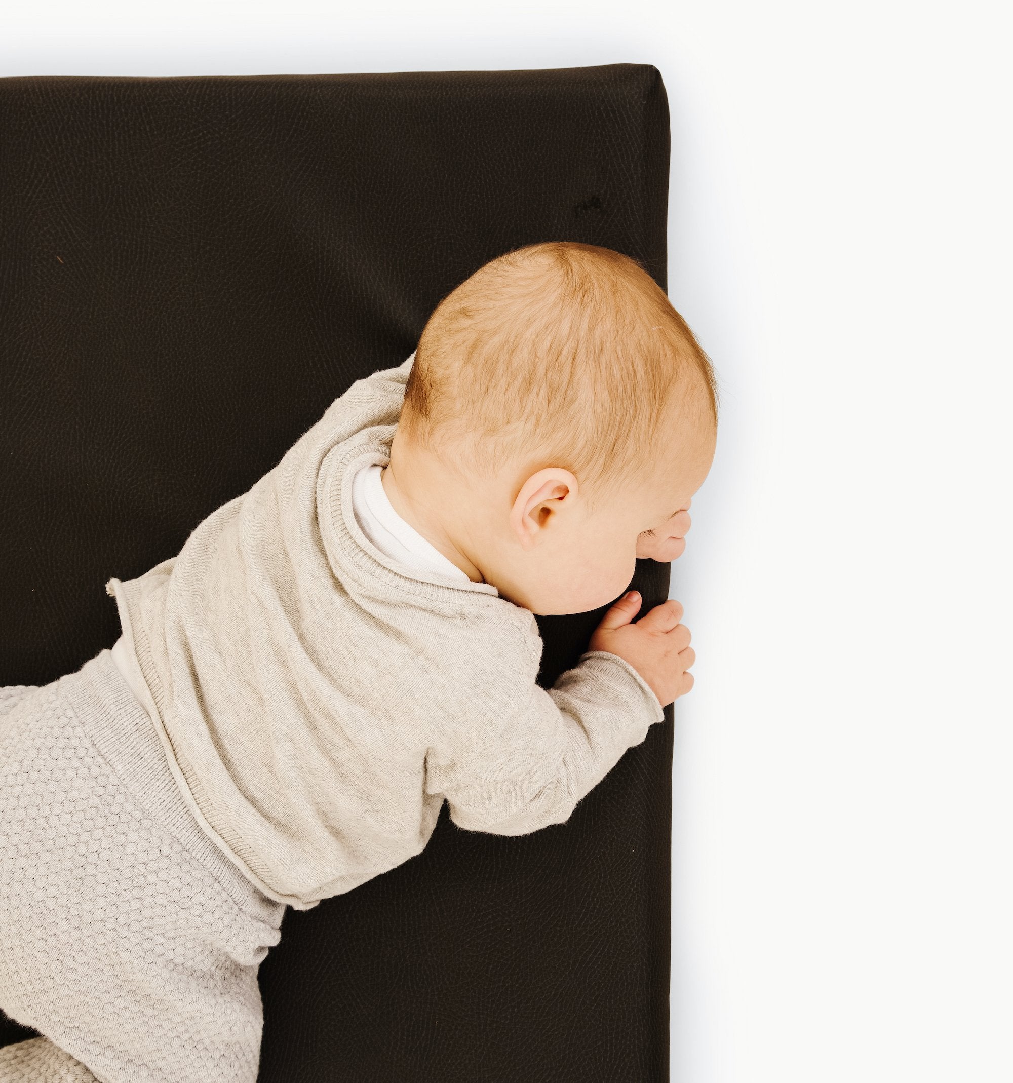Raven (on sale)@Close up of baby laying on Raven Padded Micro +