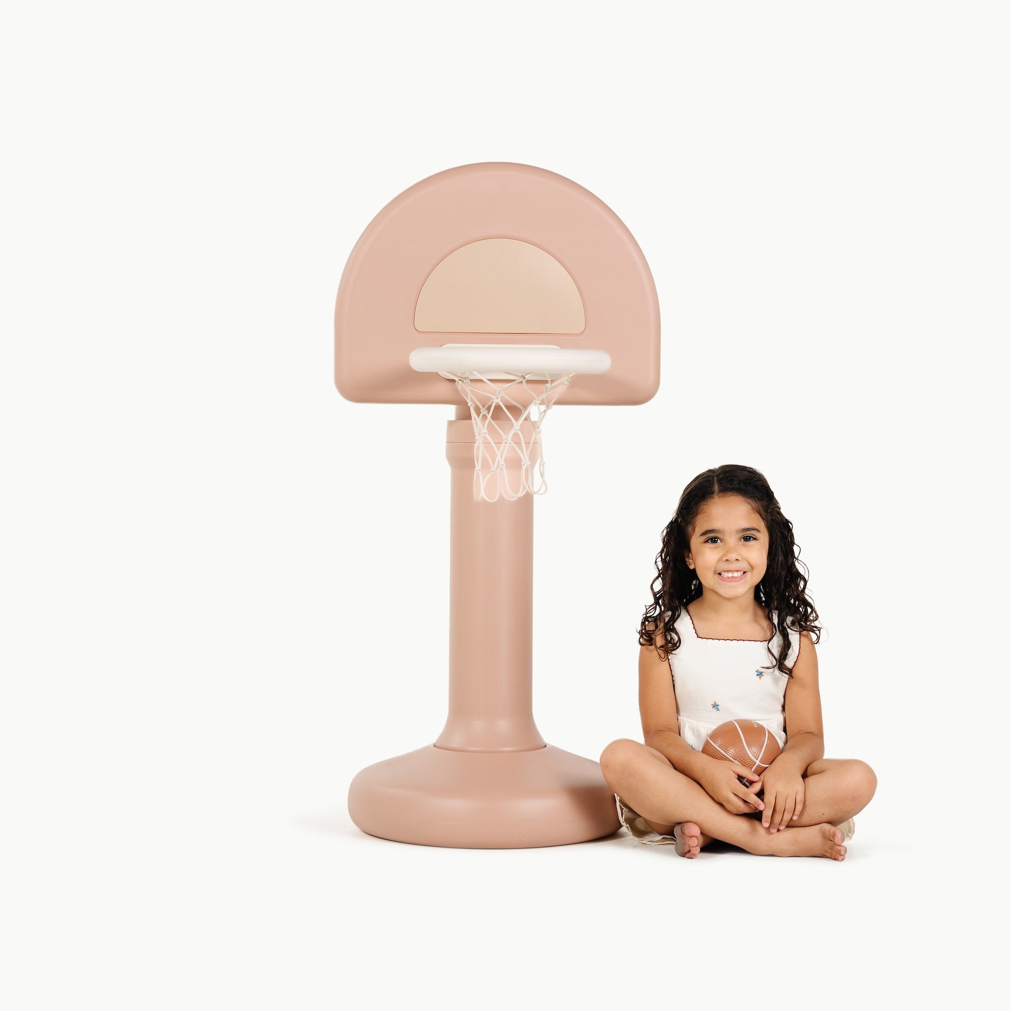 Tulle@Toddler using a basketball hoop to practice coordination and movement