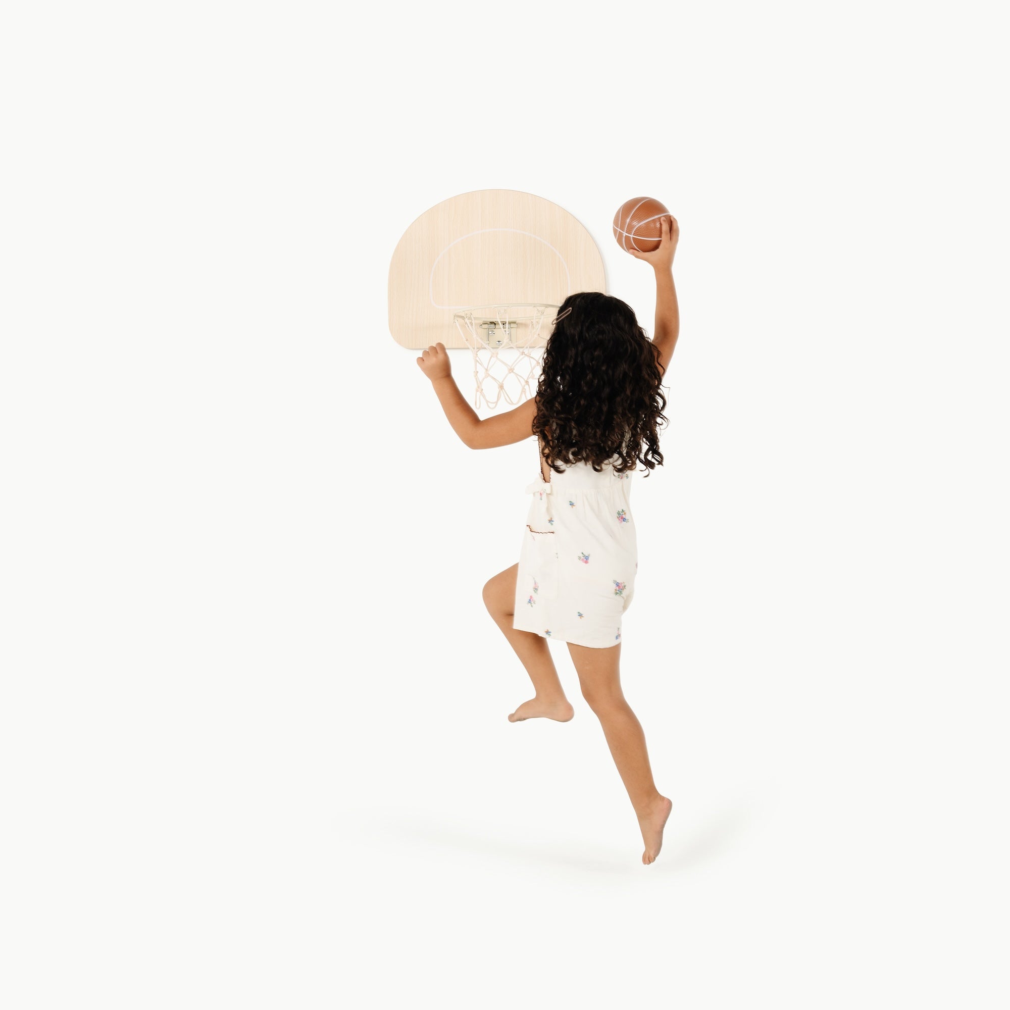 Ivory (on sale)@Child using an over-the-door basketball hoop for indoor practice