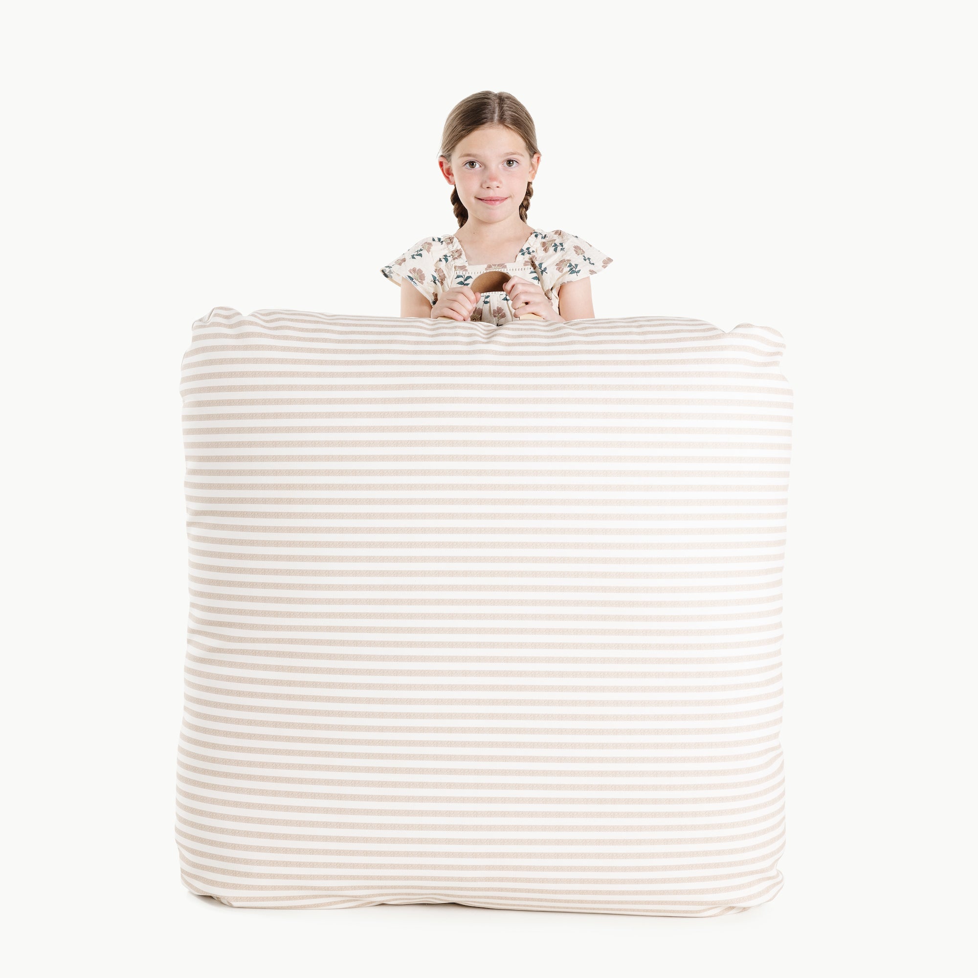 Cafe Stripe / Square@Kid holding the Cafe Stripe Square Floor Cushion