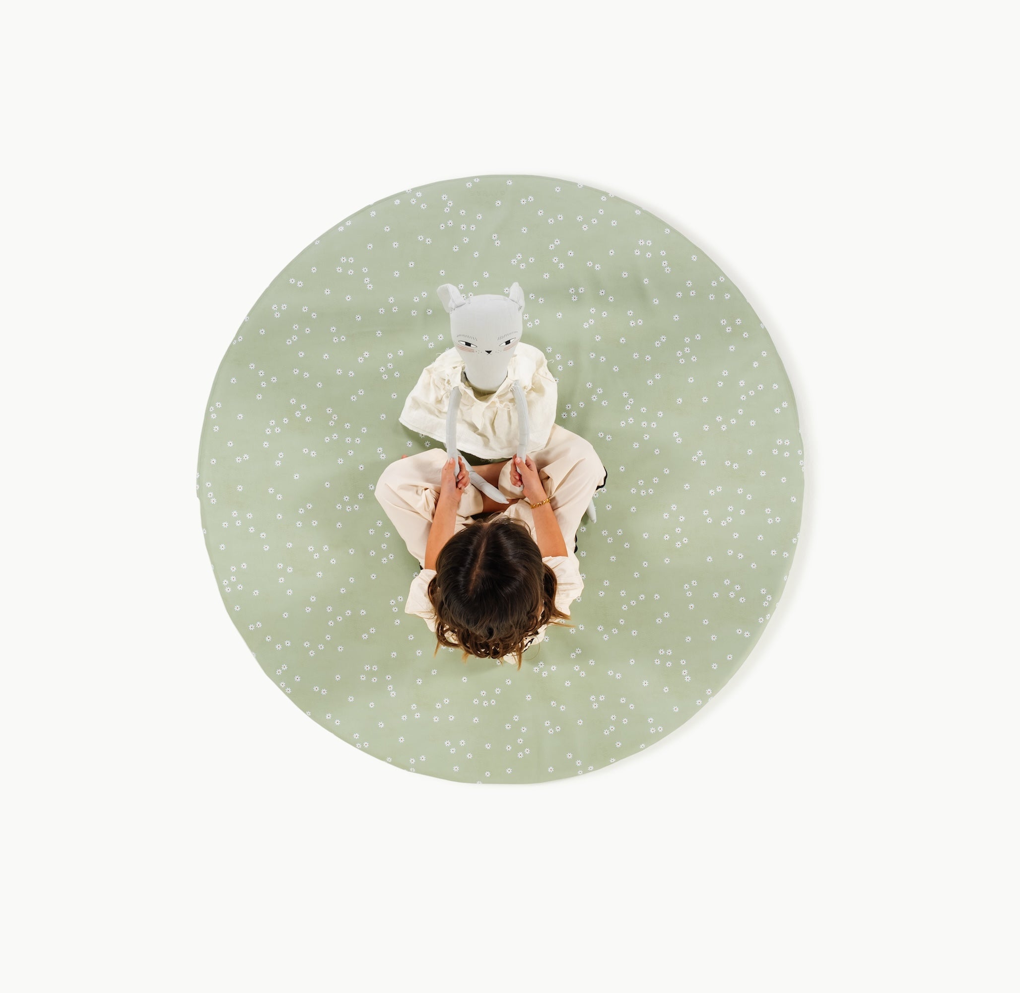 Flora (on sale)@overhead of little girl sitting on padded mat