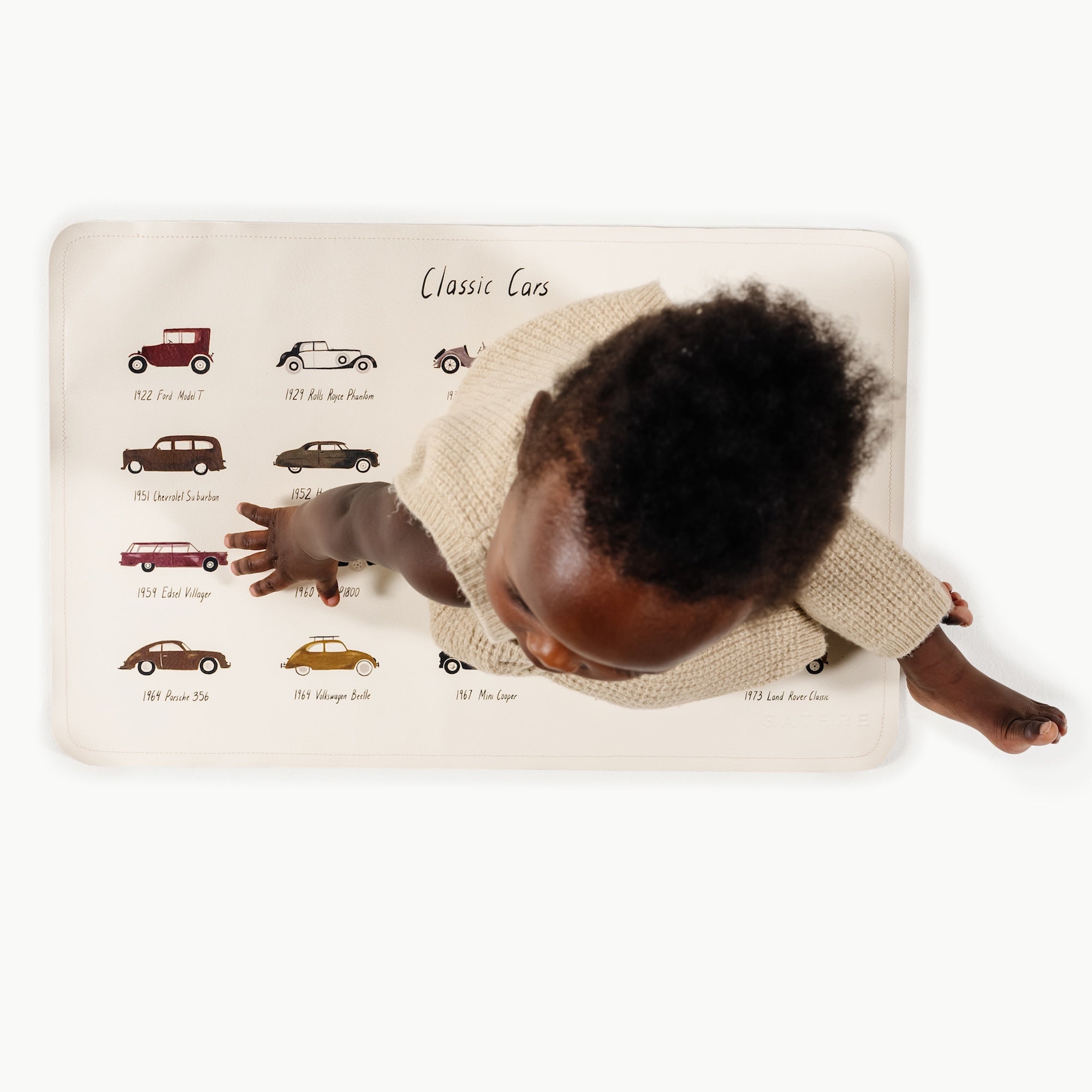 Classic Cars@overhead of little boy sitting on micro mat