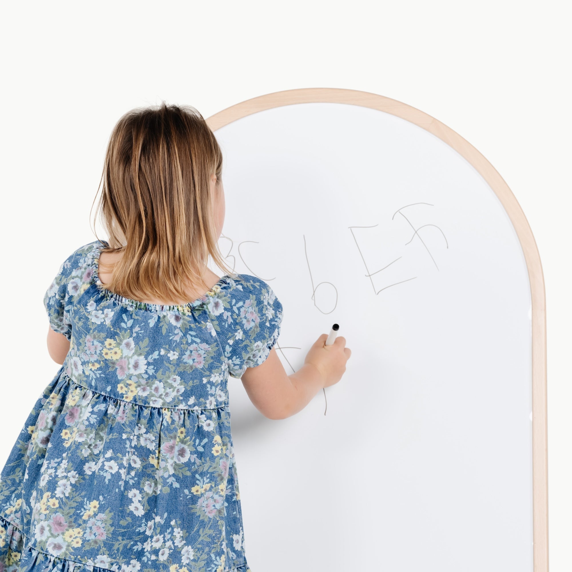 Beech@kid playing on the whiteboard side of the arched chalkboard
