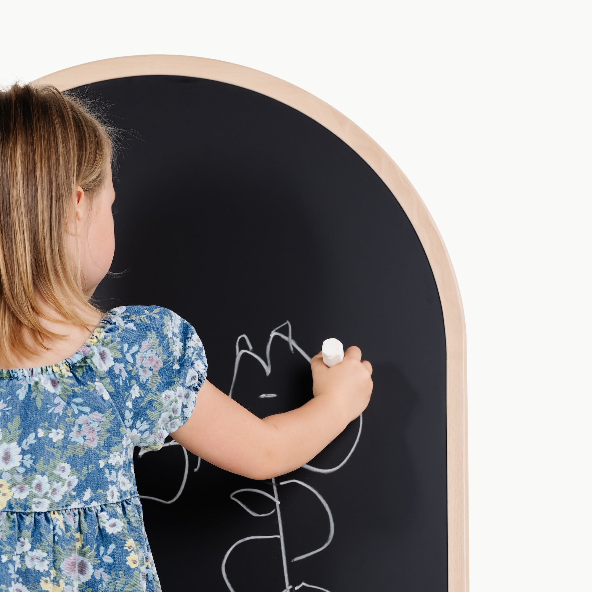 Beech@kid playing on the chalkboard side of the arched chalkboard