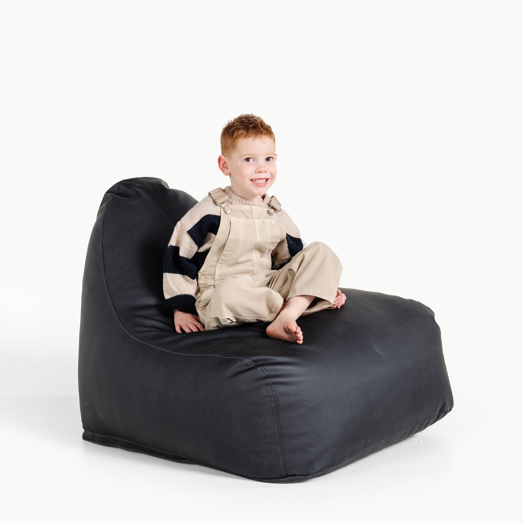 Raven@little boy sitting on lounger