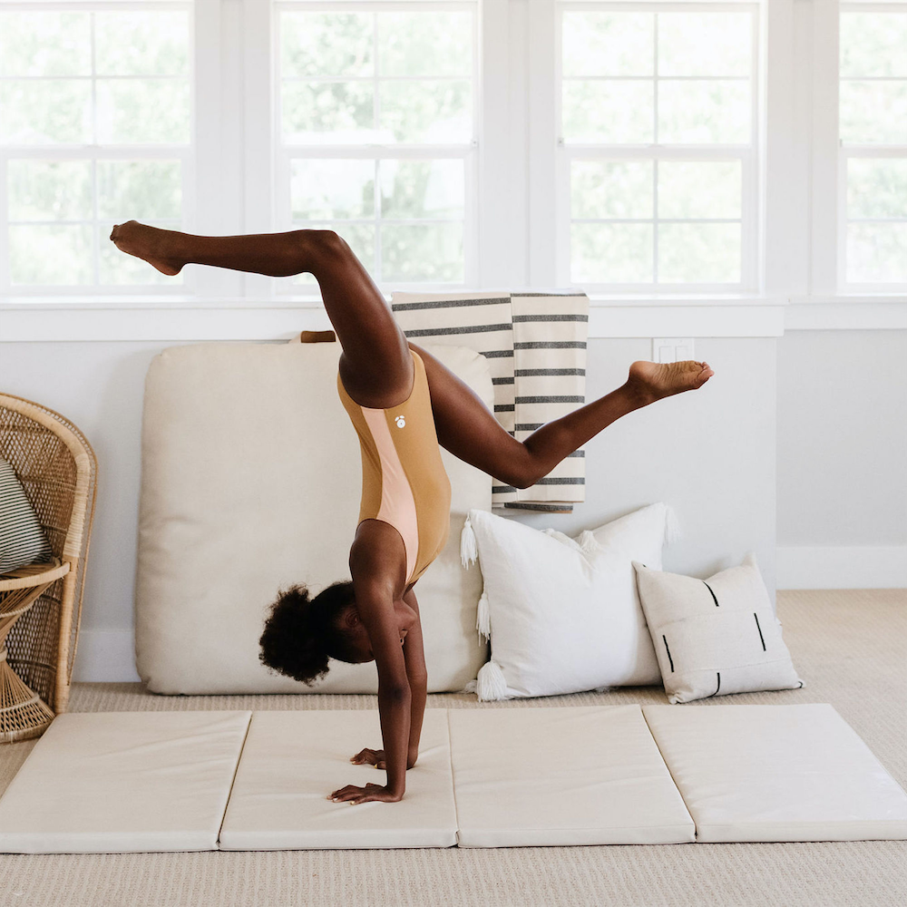 Ivory@Child rolling and playing on a comfortable tumbling mat
