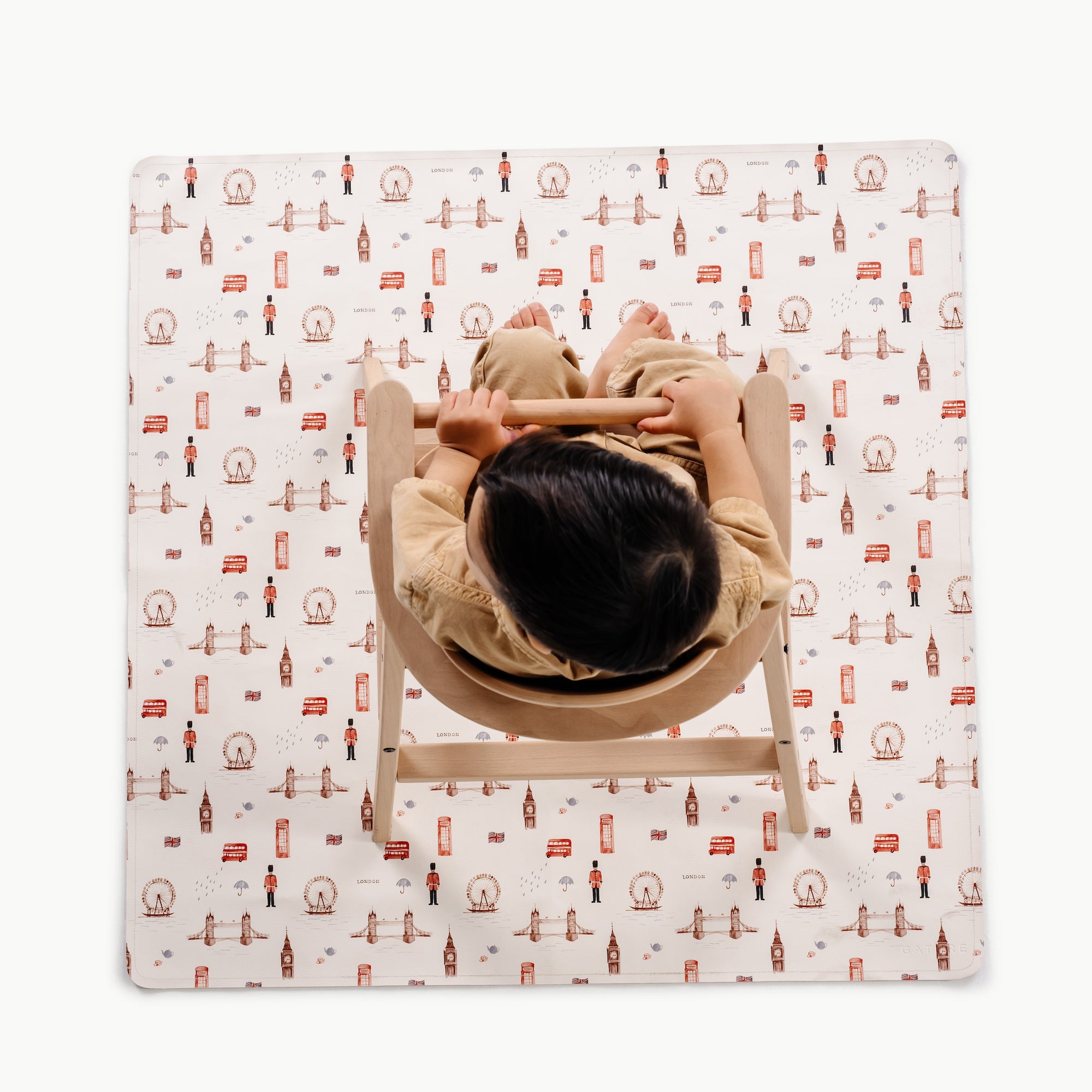 London (on sale)@overhead of kid in a highchair on the london mini mat