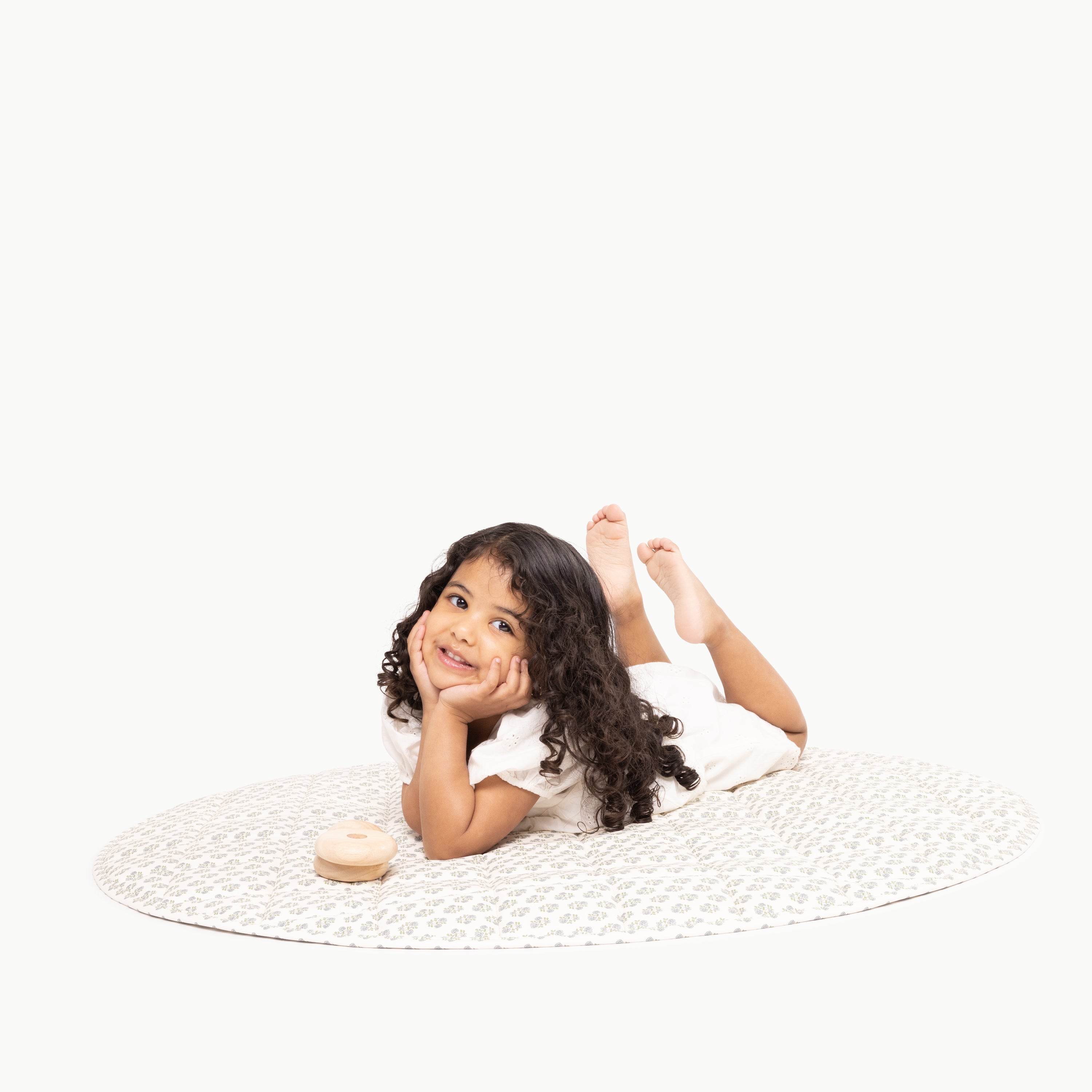 Meadow / Circle@kid laying on the meadow circle quilted mat