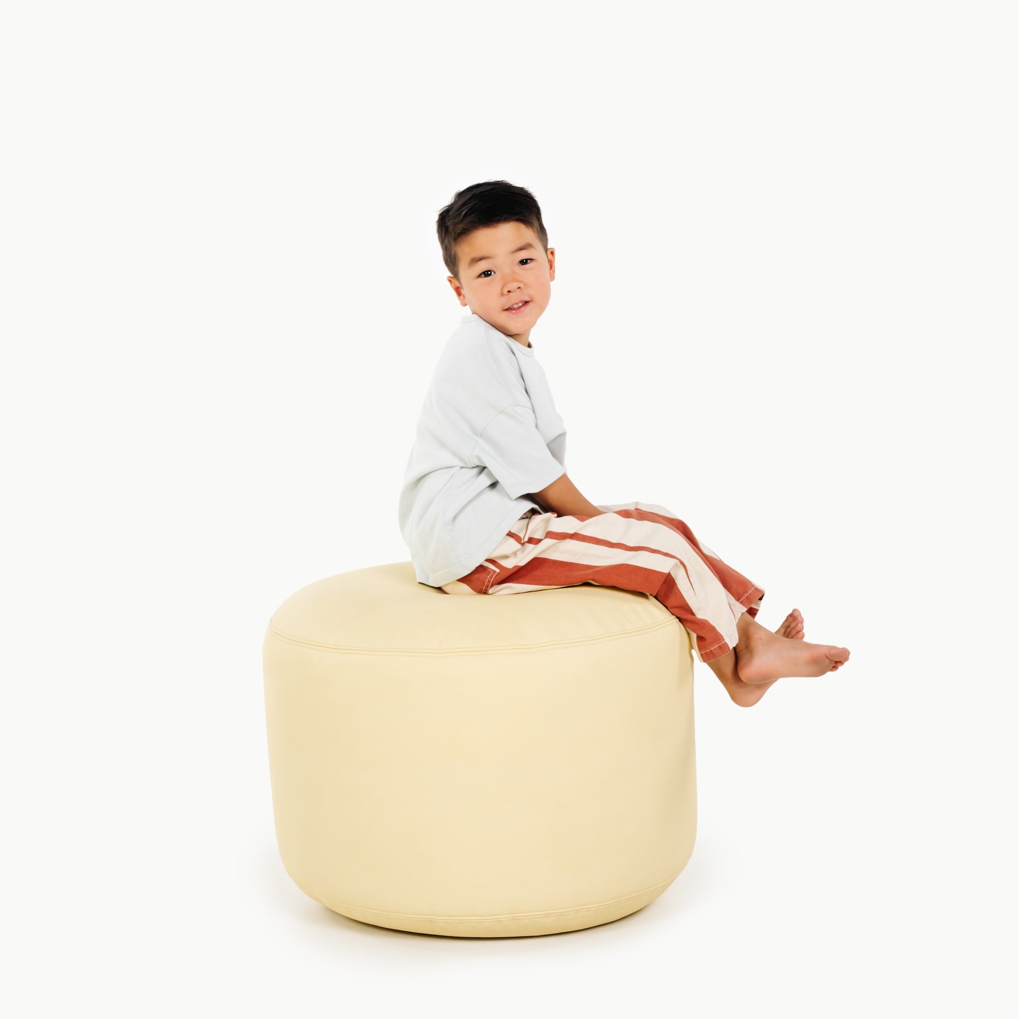 Mellow (on sale)@little boy sitting on pouf