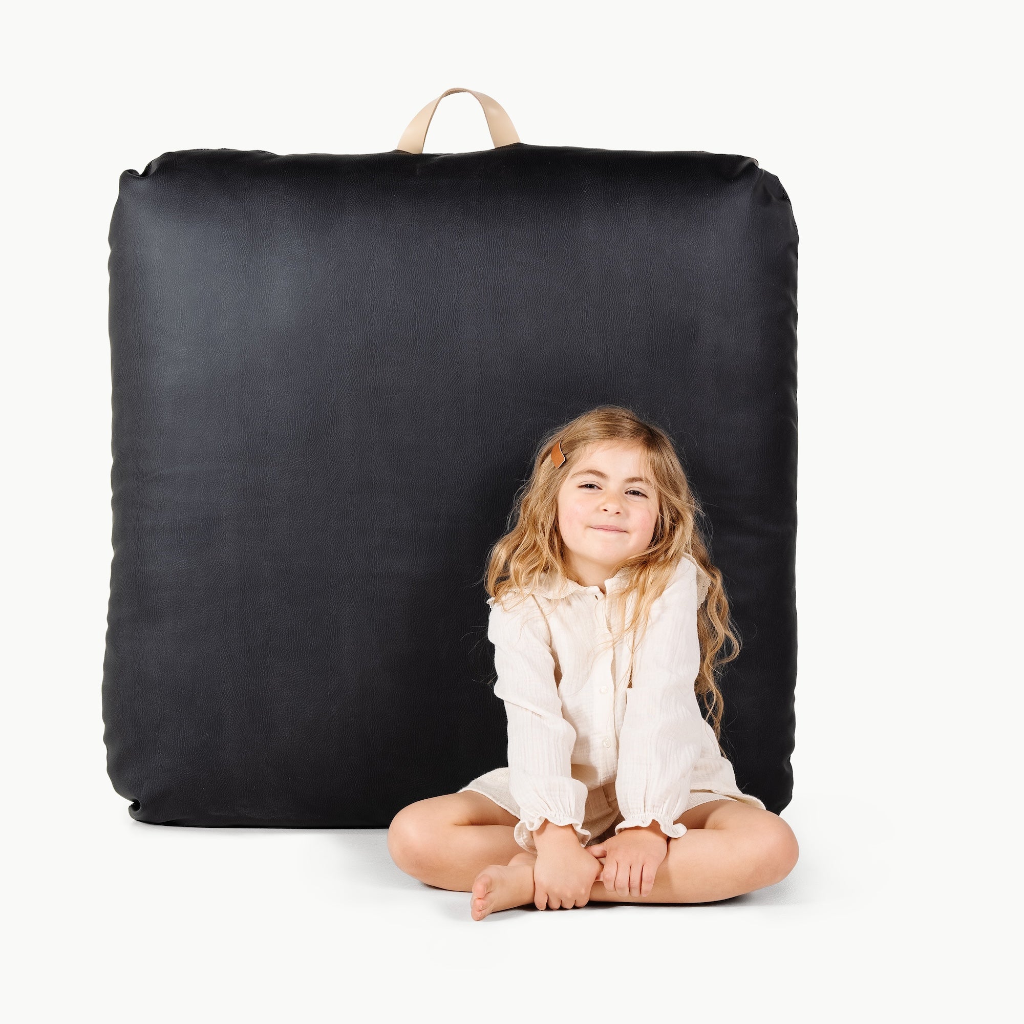 Raven (on sale) / Square@little girl in front of the Raven Square Floor Cushion