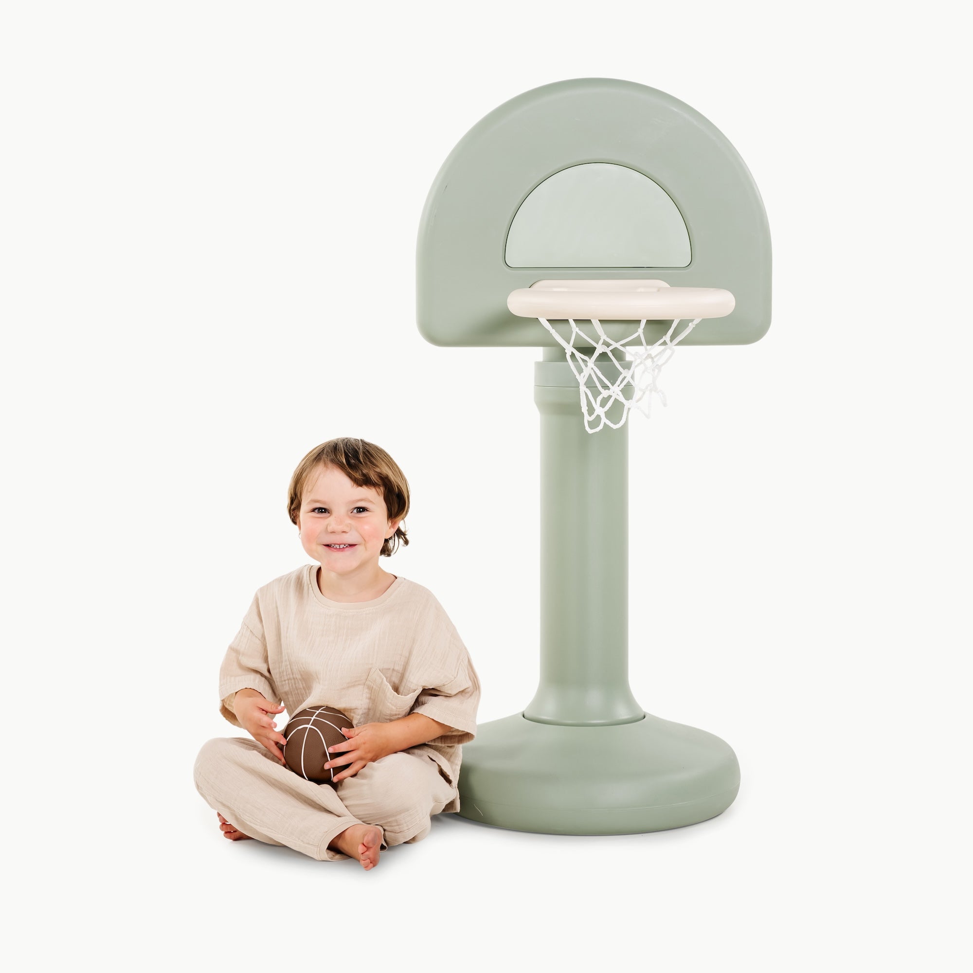 Palm@Toddler using a basketball hoop to practice coordination and movement