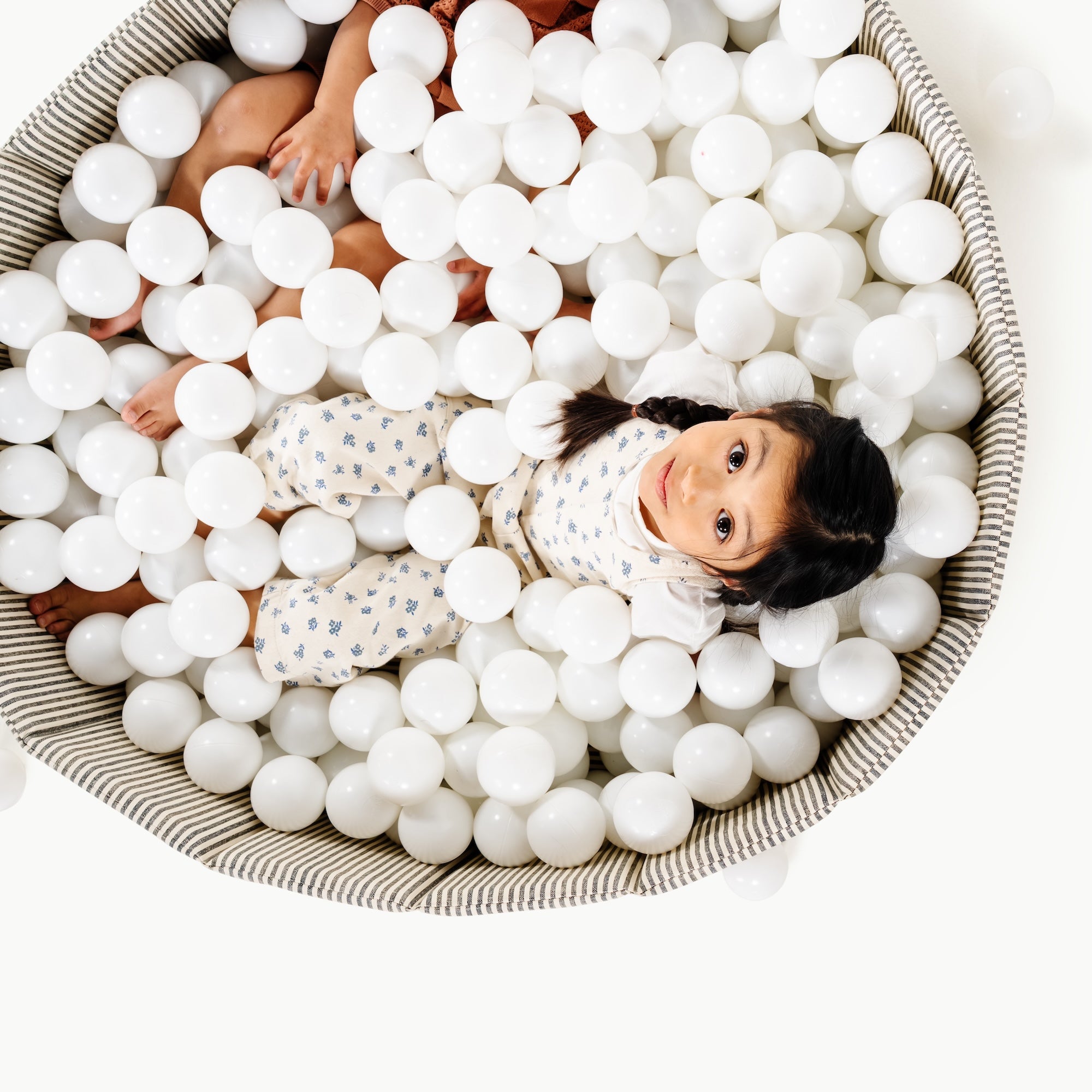 Stone Stripe@Child playing in a soft ball pit designed for babies and toddlers