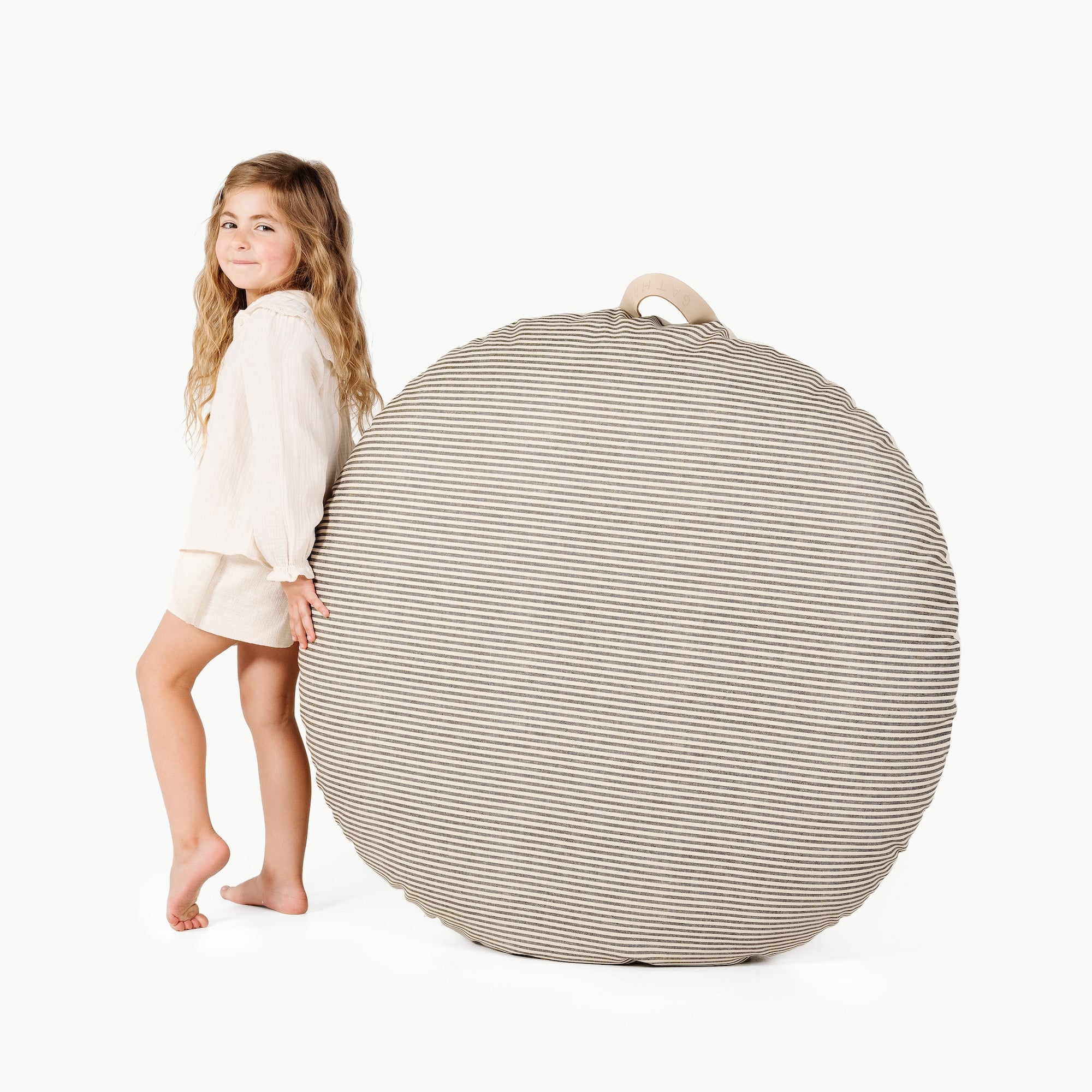 Stone Stripe / Circle@little girl holding the Stone Stripe Circle Floor Cushion