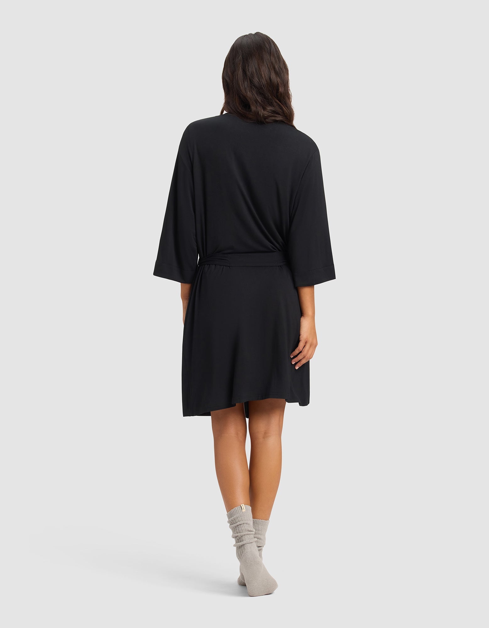 Black@woman wearing a black cozy earth robe