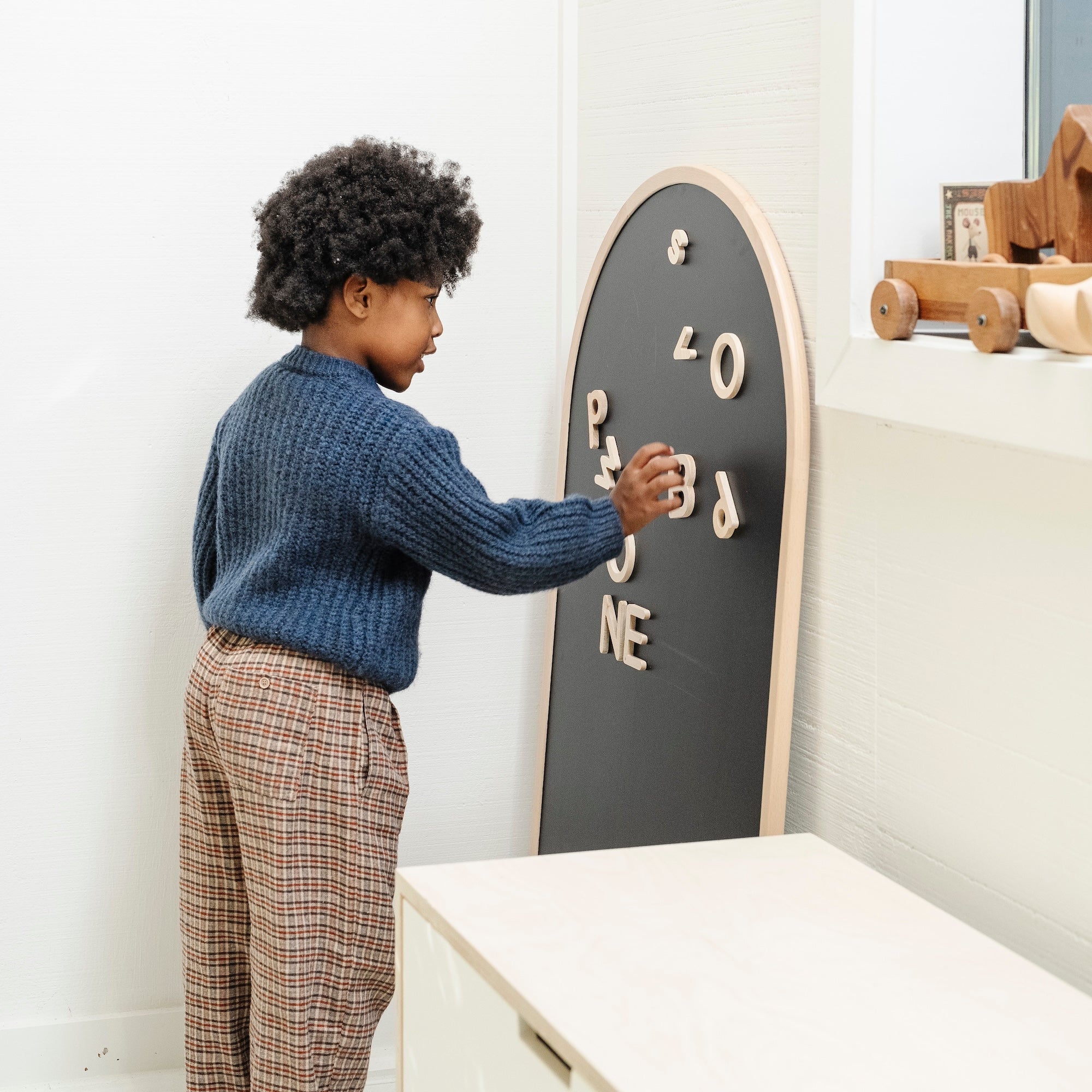 Beech@Child using a kids chalkboard for drawing and magnetic play at home