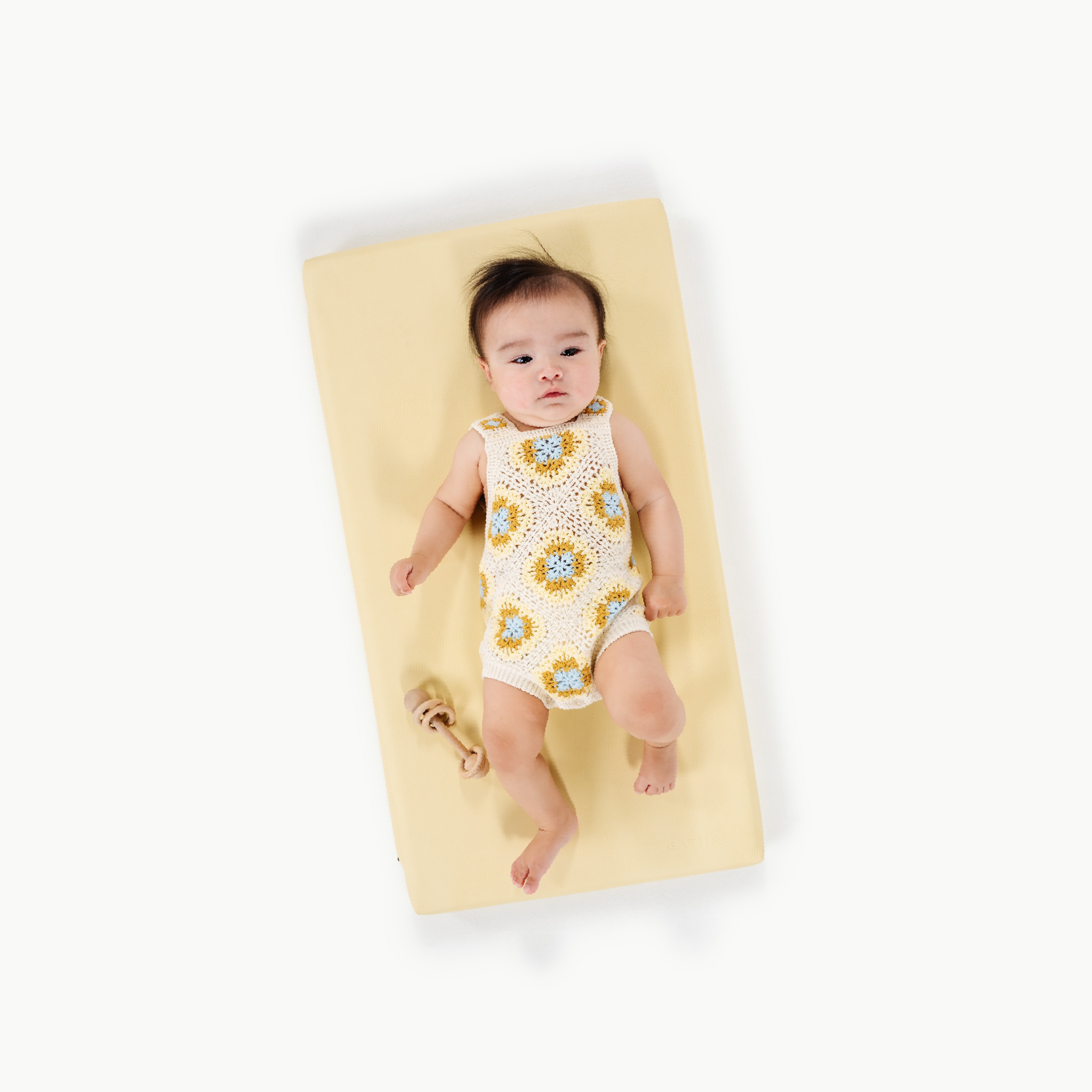 Mellow (on sale)@overhead of a baby on a padded micro+