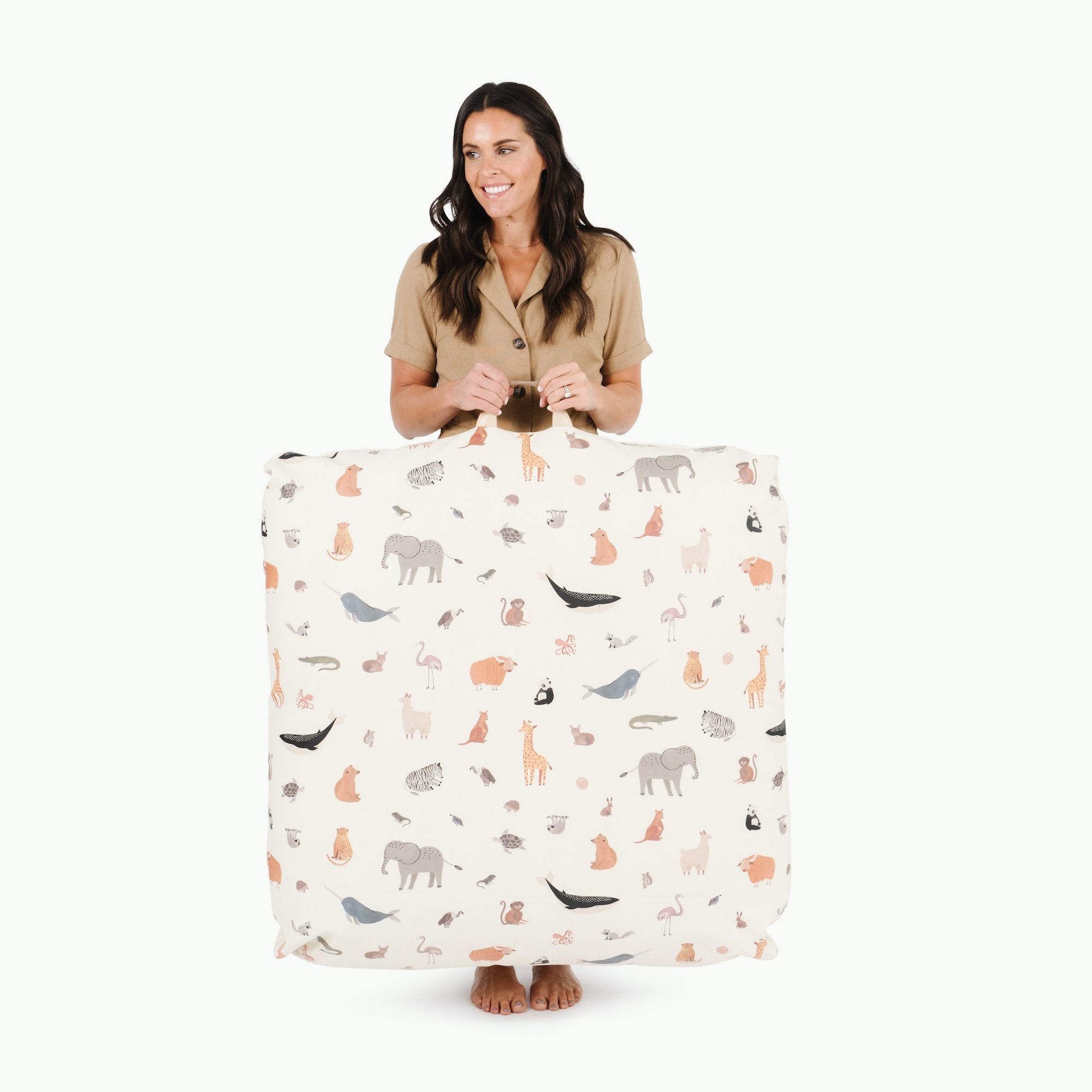 Menagerie (on sale) / Square@woman holding the menagerie square floor cushion