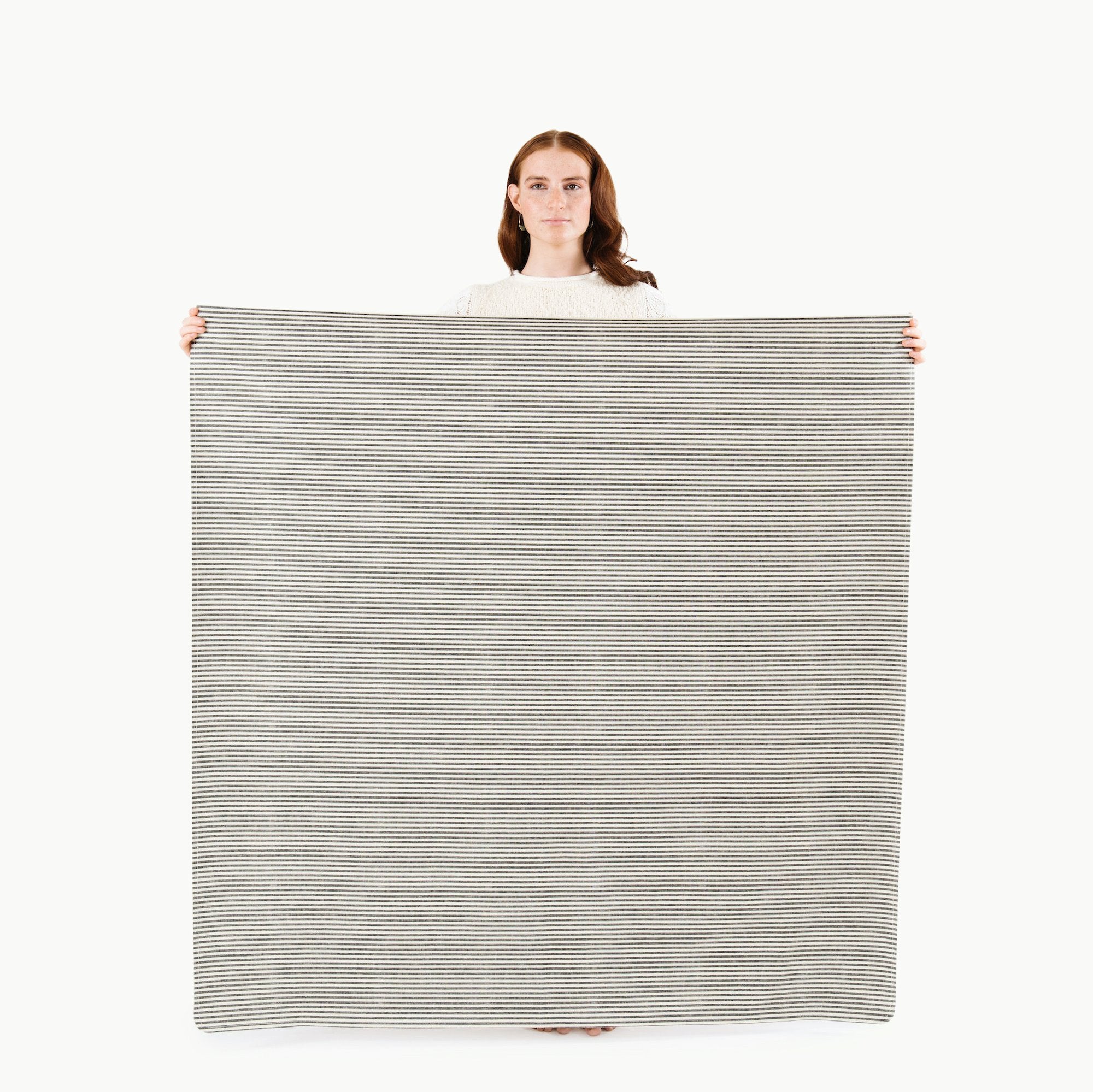 Stone Stripe (on sale) / Square@Woman holding the Stone Stripe Midi Square Mat