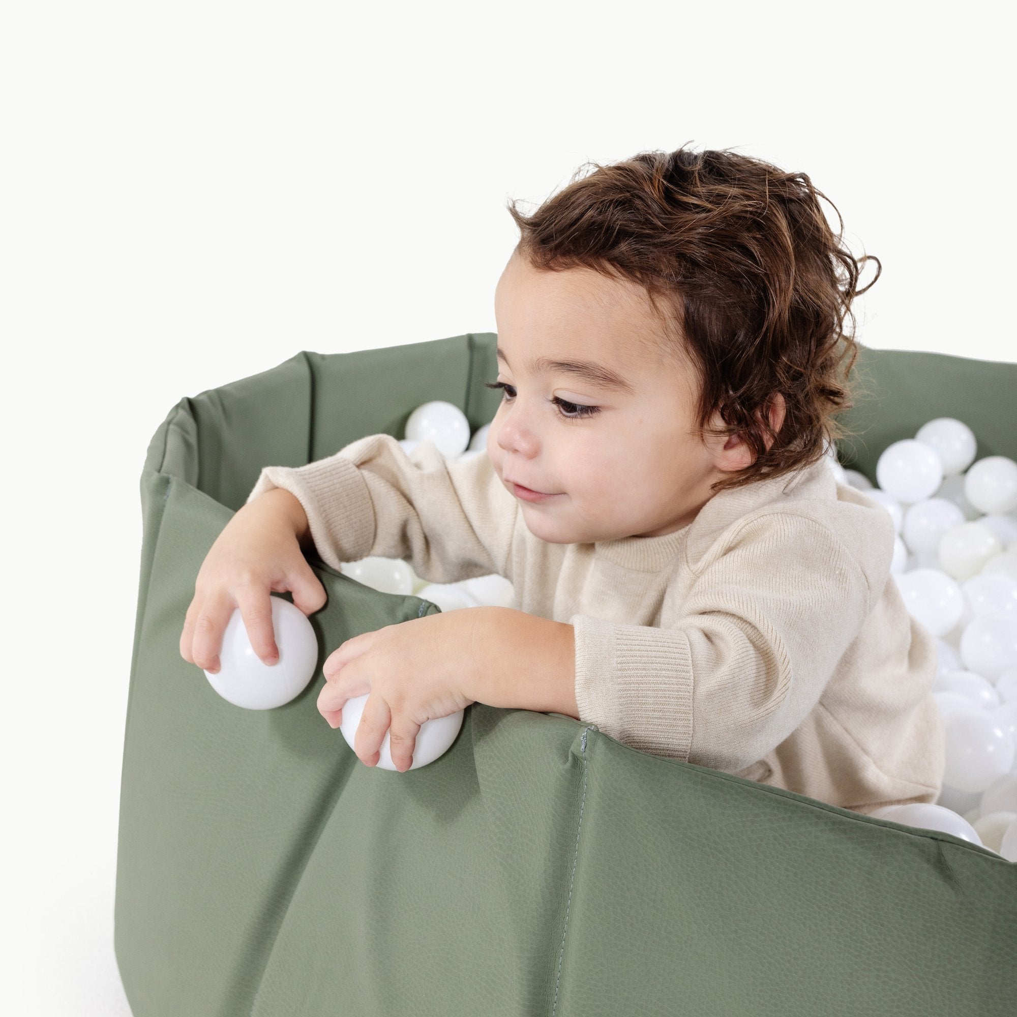 Thyme@Child playing in a soft ball pit designed for babies and toddlers