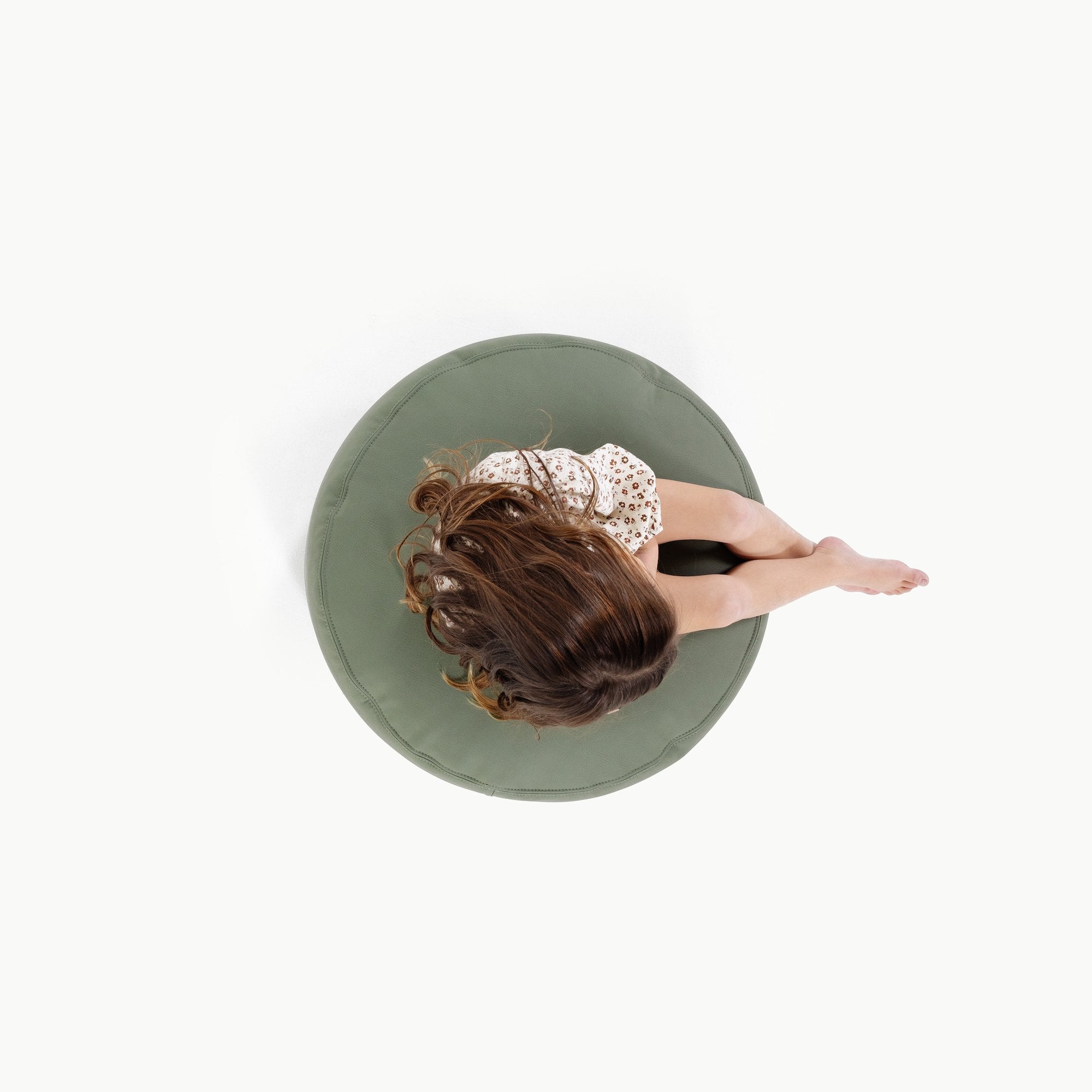 Thyme@Overhead of kid sitting on a Thyme Circle Pouf