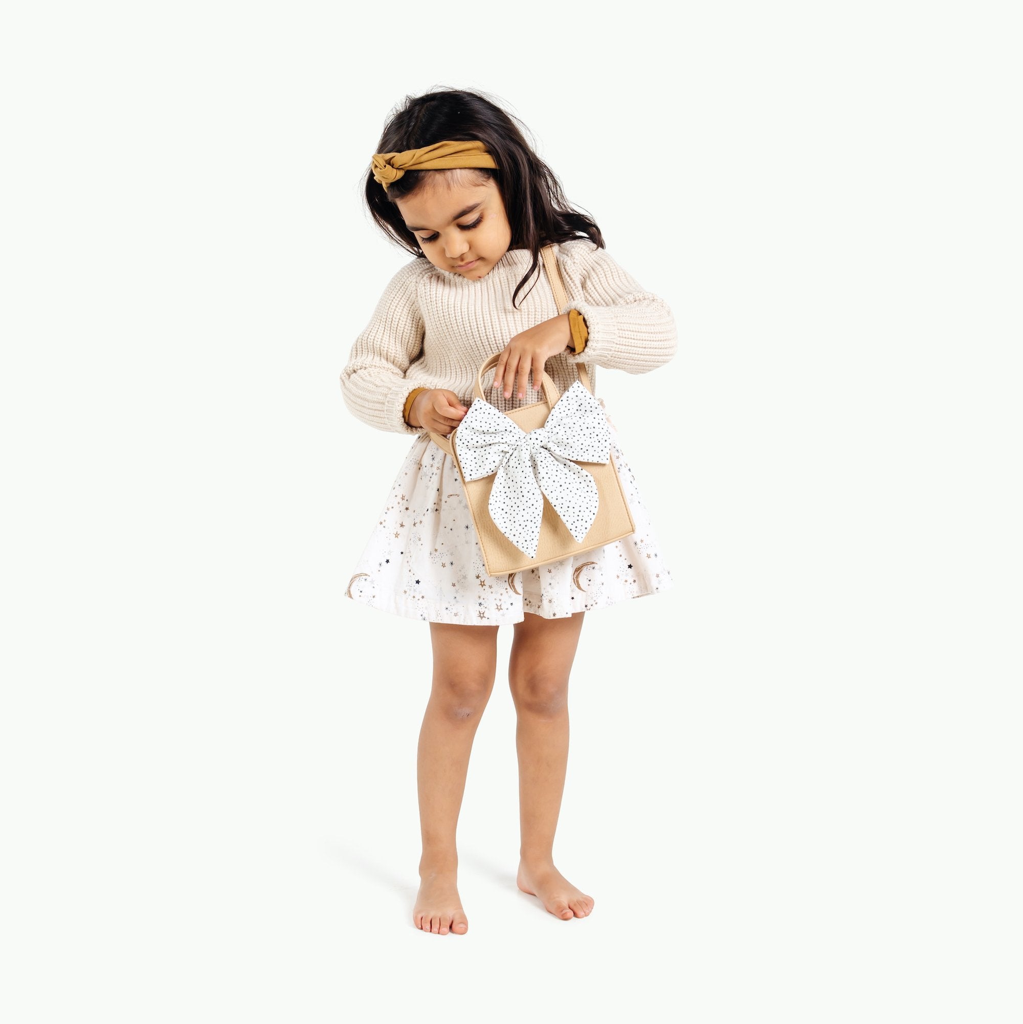 Untanned (on sale)@Little girl looking inside the Untanned Children's Purse