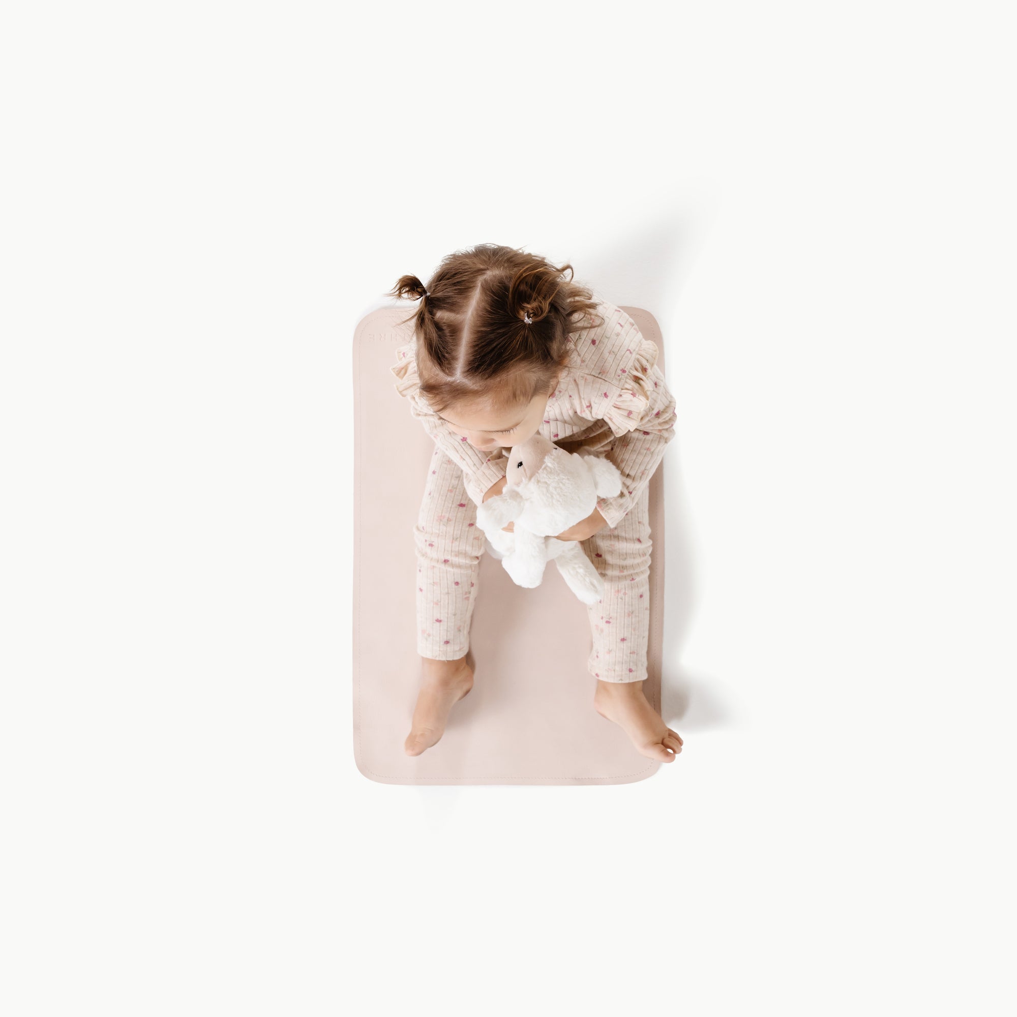 Belle@Overhead photo of girl sitting on Belle Changing Mat
