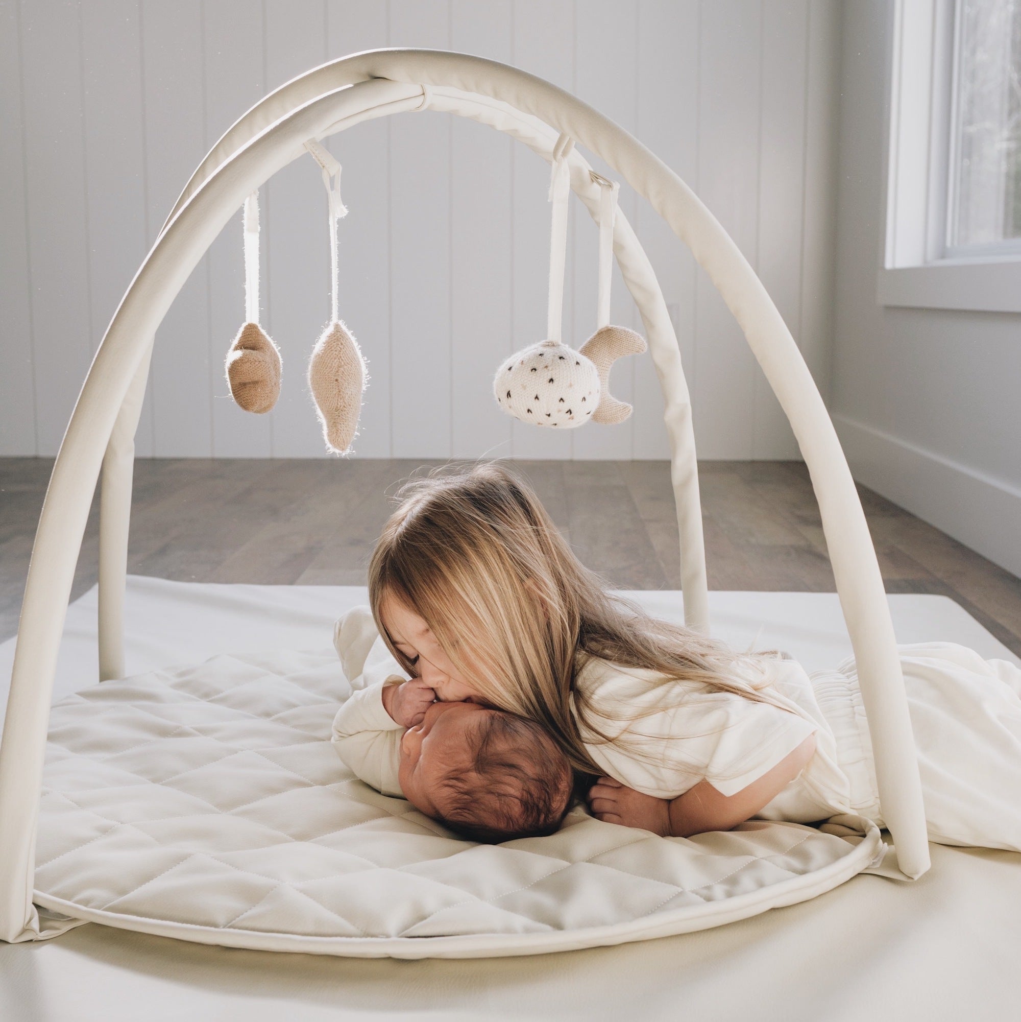 Ivory@Baby and sibling on the baby activity gym.