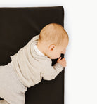 Raven (on sale)@Close up of baby laying on Raven Padded Micro +