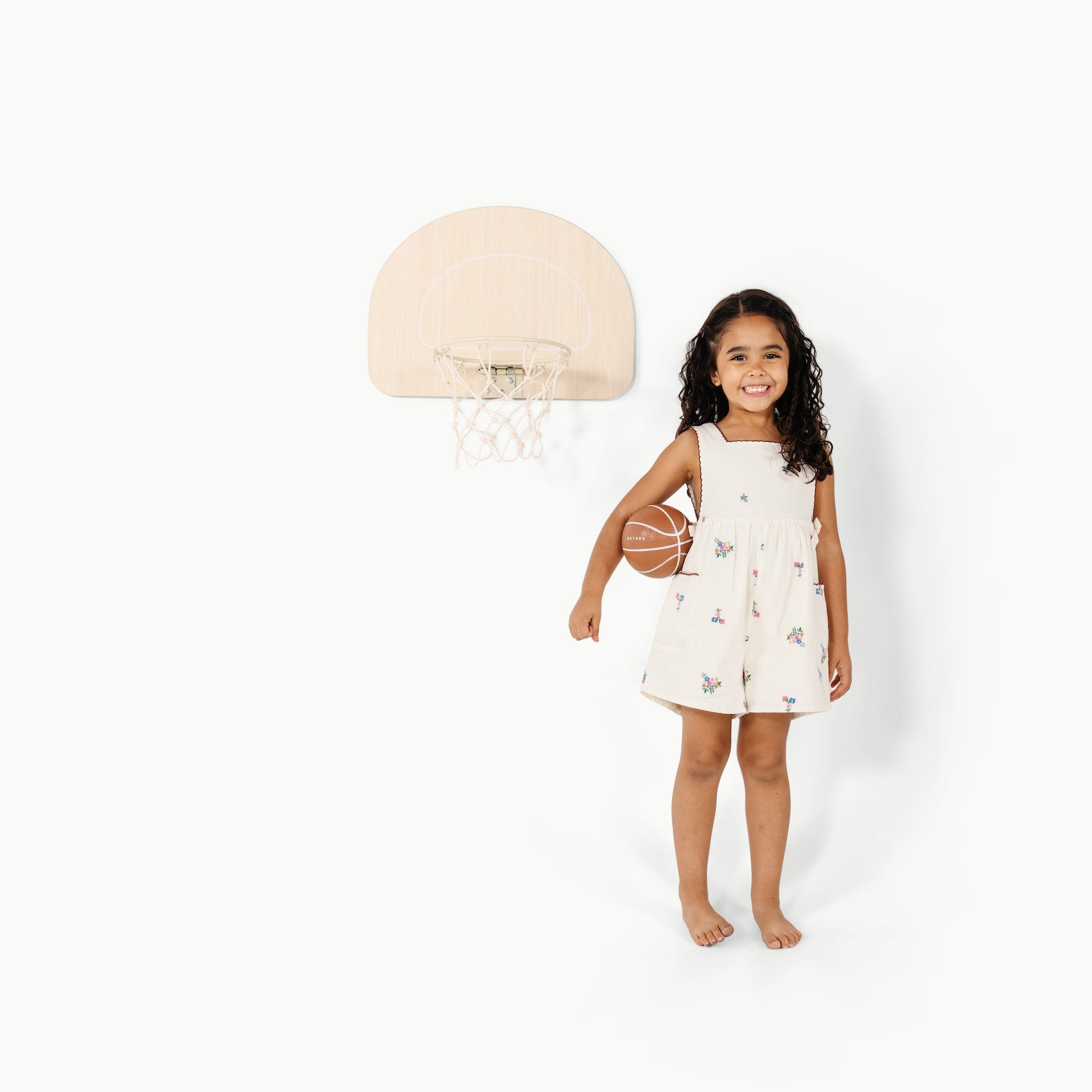 Ivory (on sale)@Child using an over-the-door basketball hoop for indoor practice
