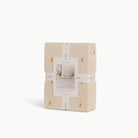 Ivory@Cotton knit throw blanket with dotted texture and scalloped edge in packaging 