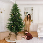 Baltic@Gathre Tree Skirt under a tree in a home with people around it