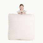 Cafe Stripe / Square@Kid holding the Cafe Stripe Square Floor Cushion