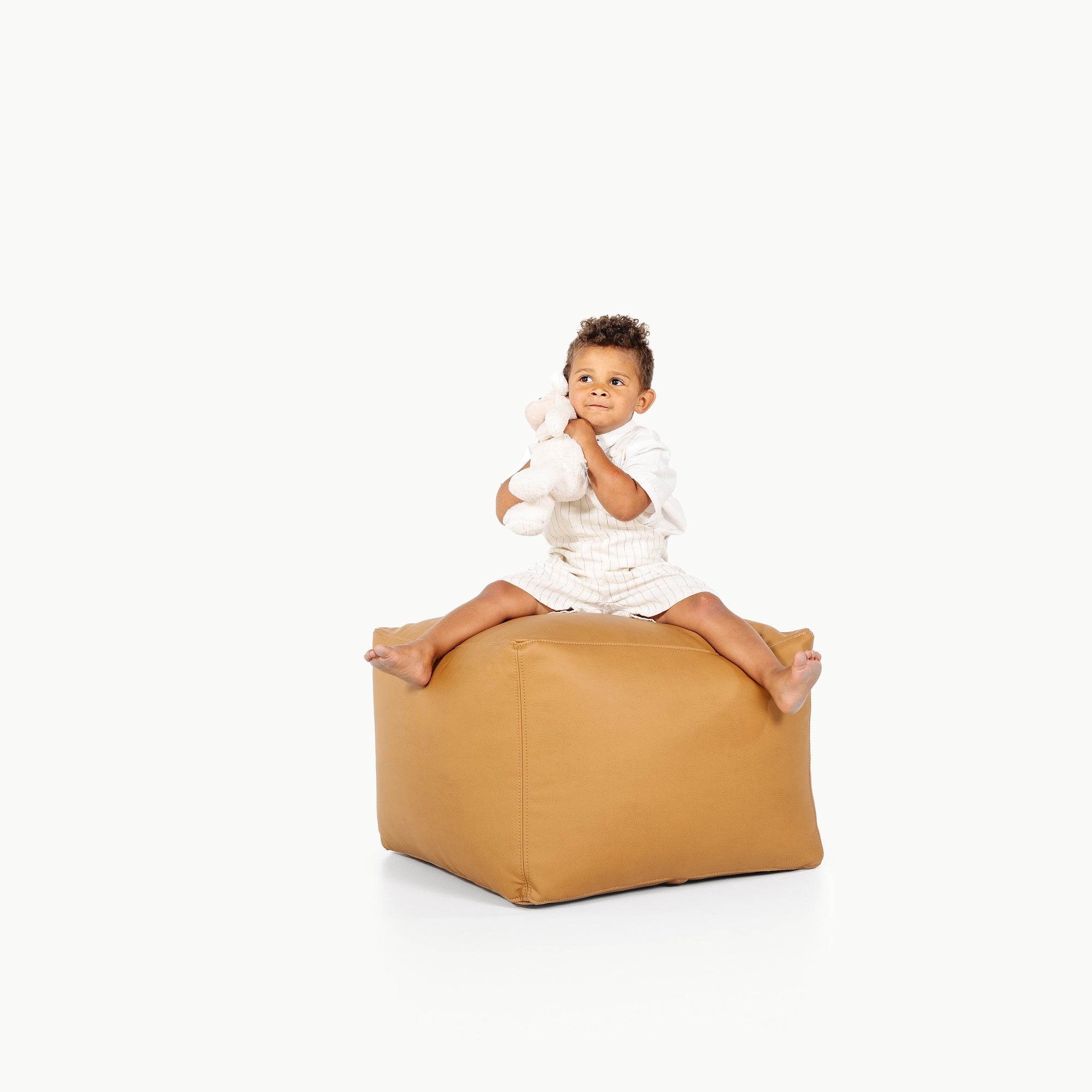 Camel@little boy sitting on the Camel Square Pouf