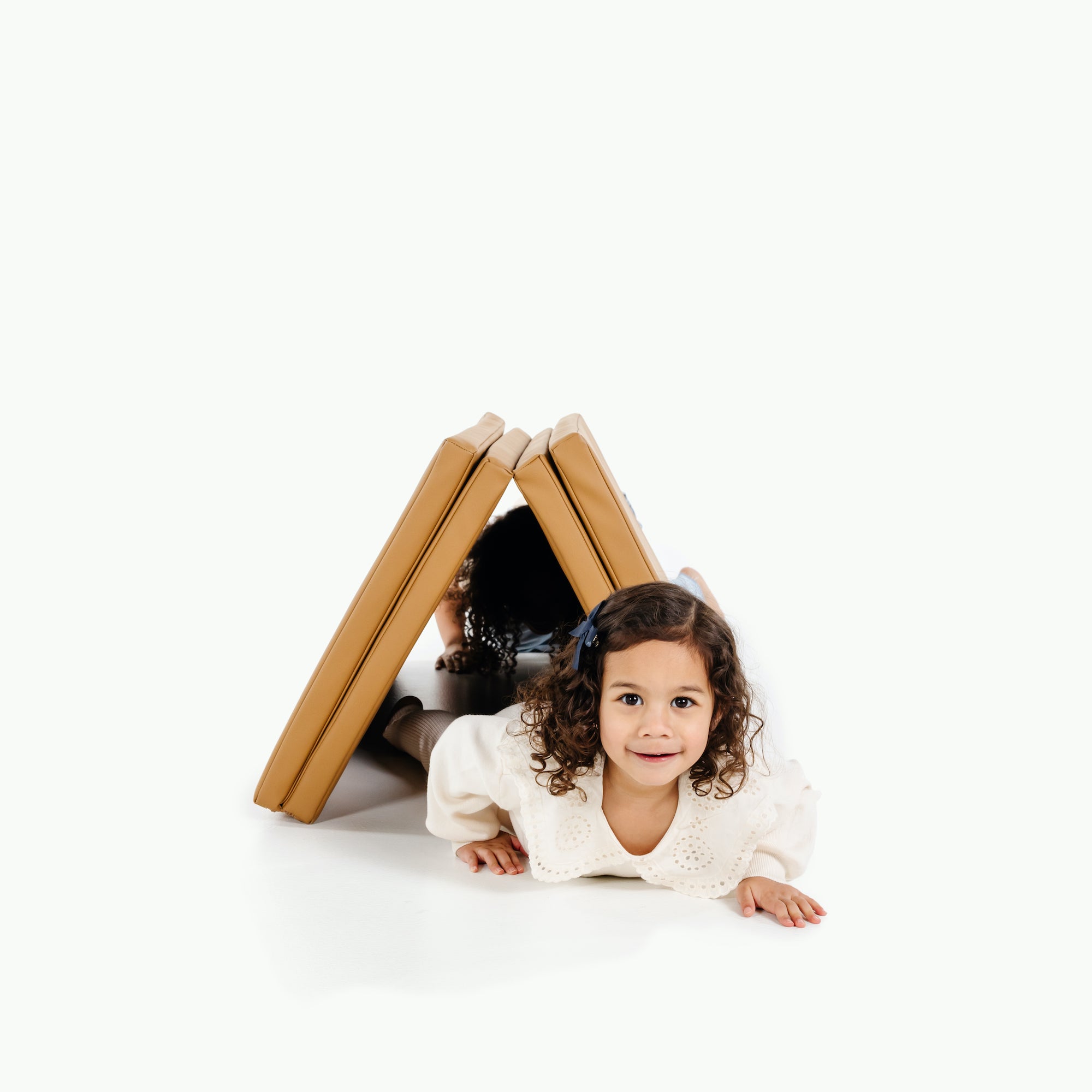 Camel@Child rolling and playing on a comfortable tumbling mat