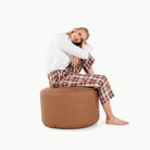 Cedar (on sale)@woman sitting on the cedar circle pouf