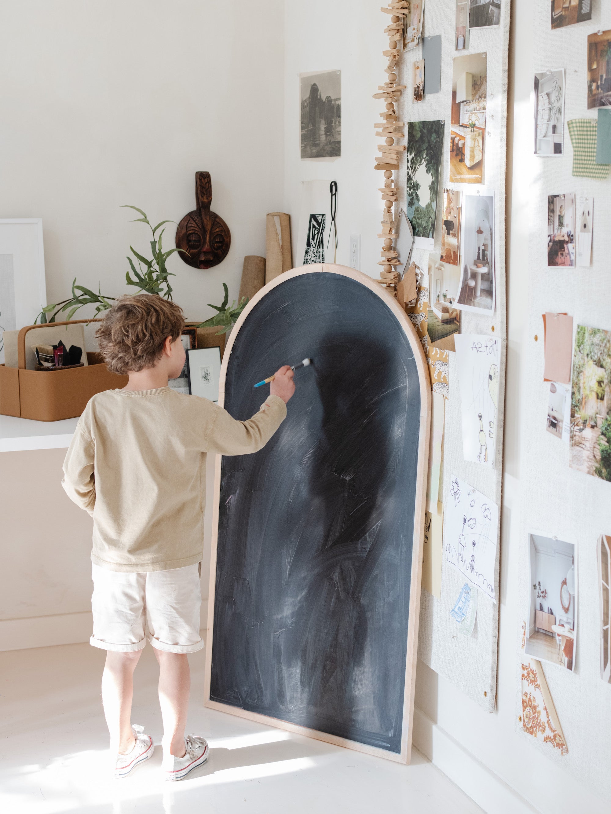Little kid drawing on the Arched Chalkboard.