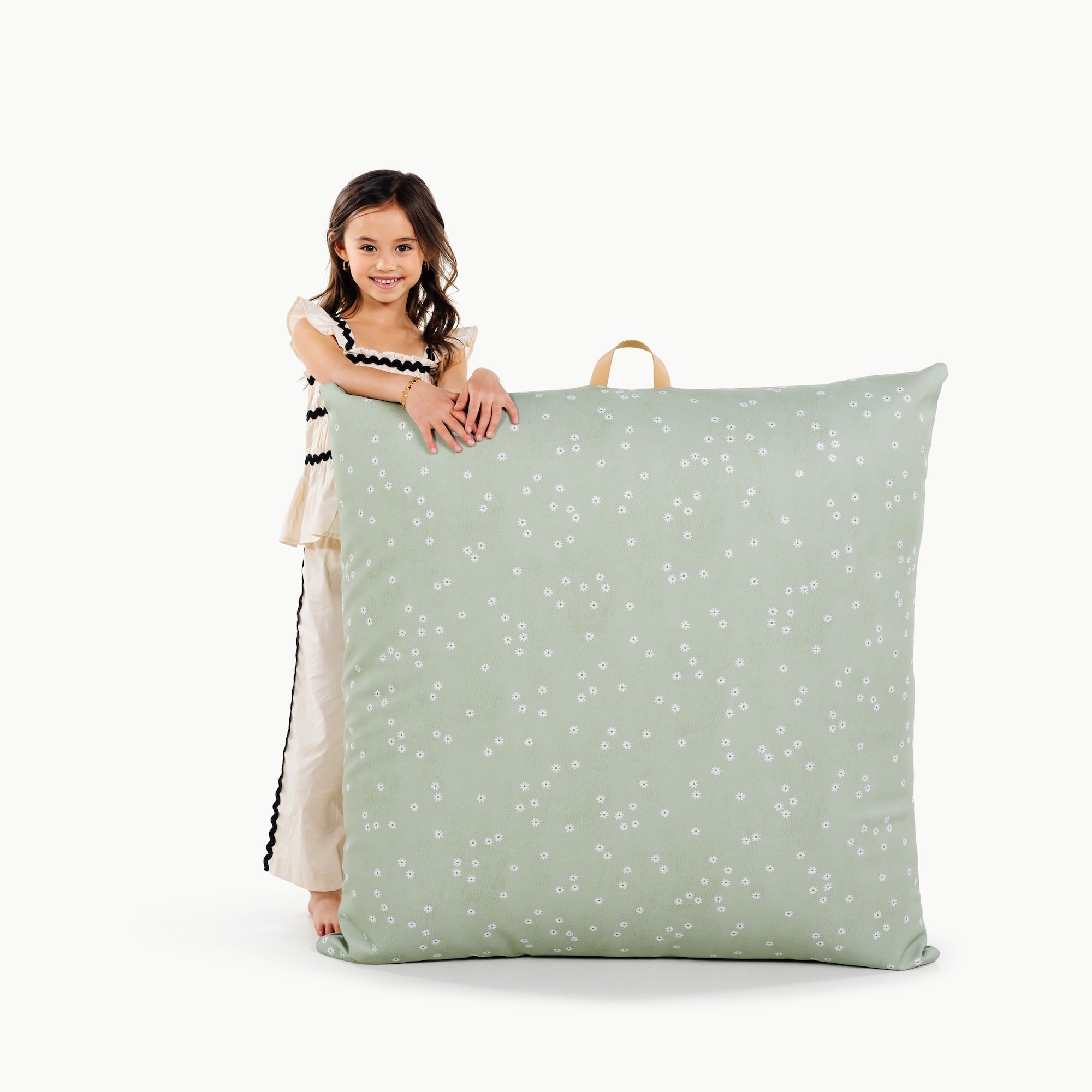Flora (on sale) / Square@little girl holding a floor cushion