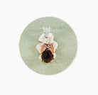 Flora (on sale)@overhead of little girl sitting on padded mat