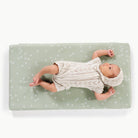 Flora (on sale)@overhead of baby on a padded micro+
