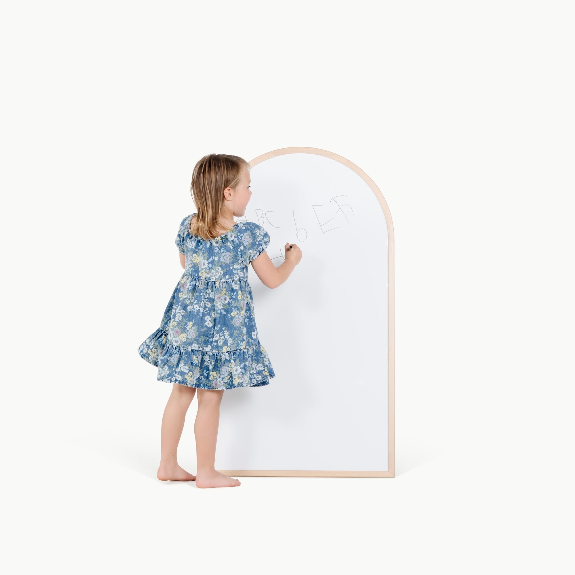 Beech@kid playing on the whiteboard side of the arched chalkboard