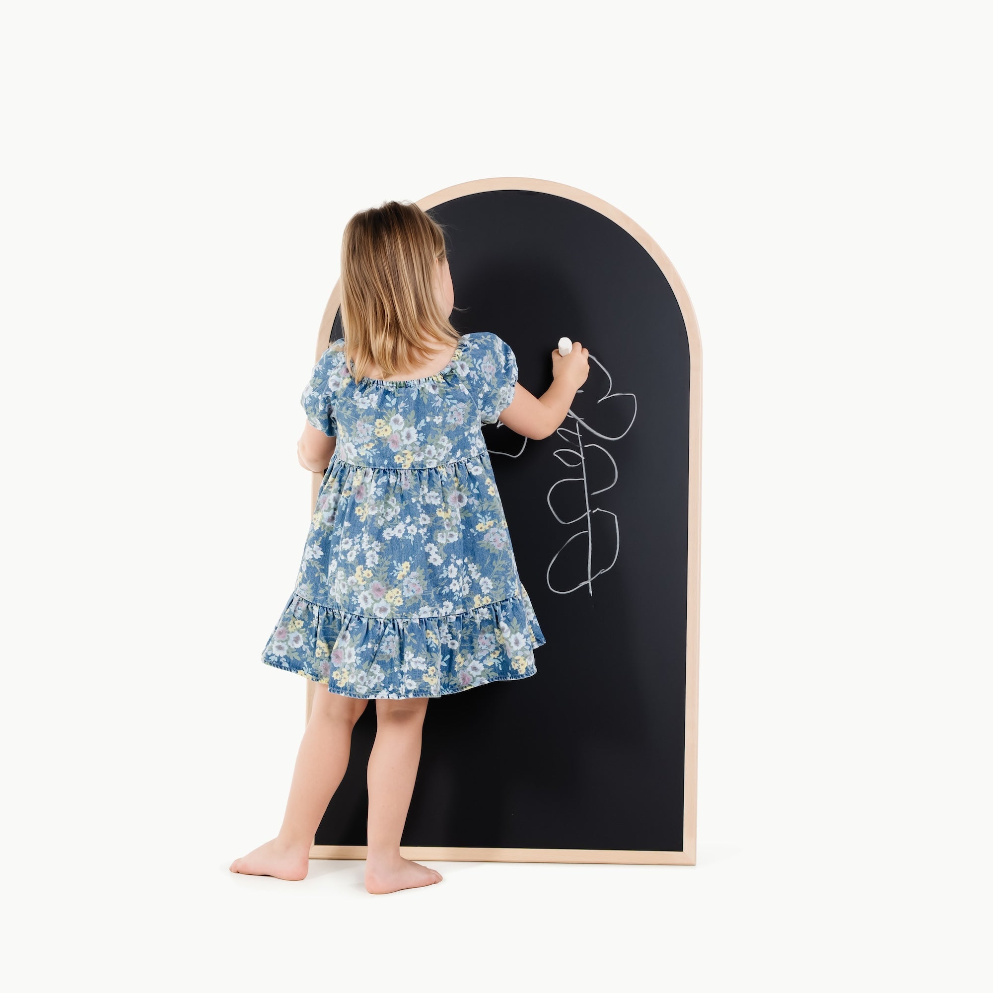 Beech@kid playing on the chalkboard side of the arched chalkboard
