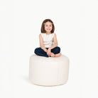 Pinstripe (on sale)@little girl sitting on a circle pouf