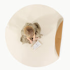 Camel • Ivory / Circle@overhead of little girl playing on mat