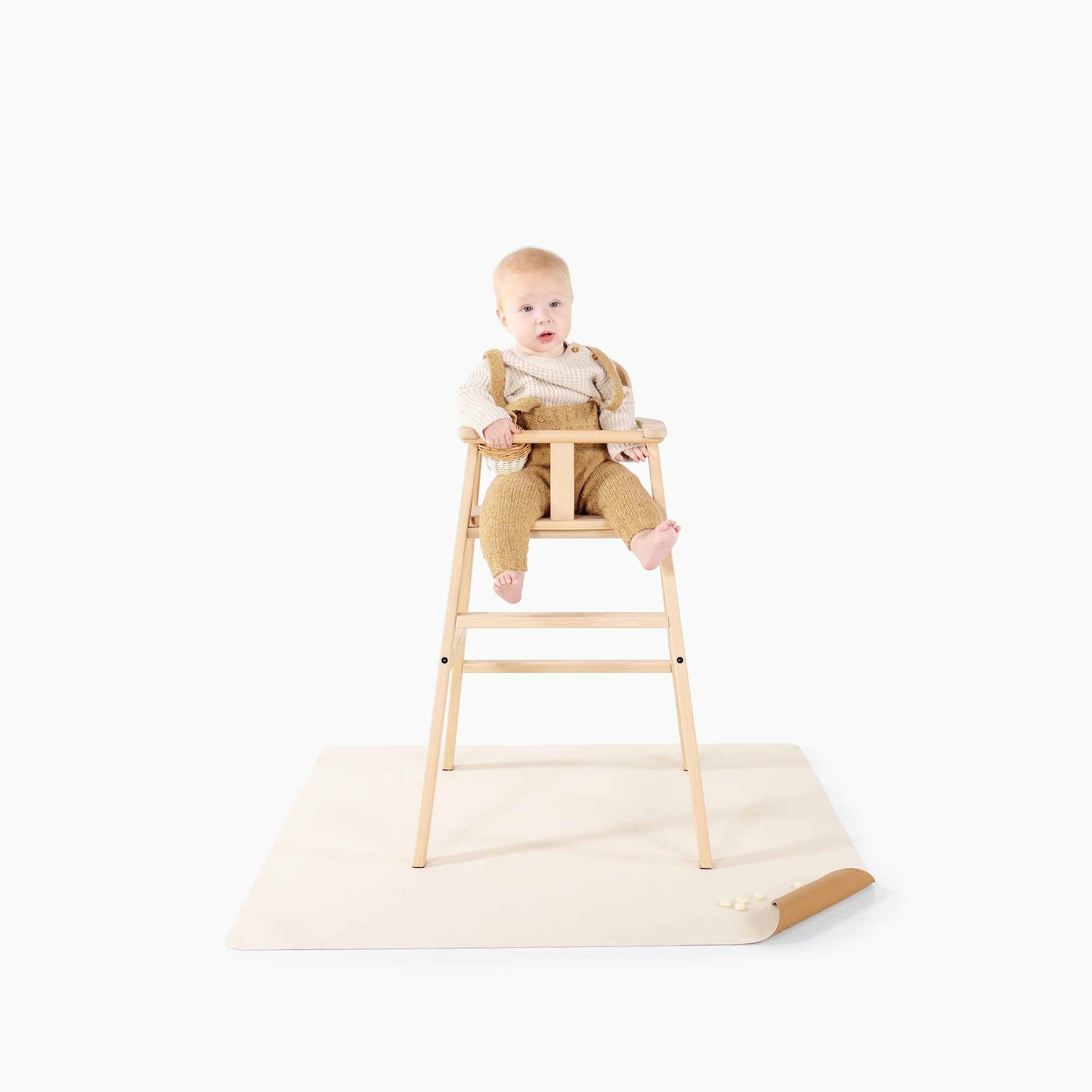 Camel • Ivory (on sale)@baby in a high chair on top of a mini mat