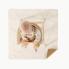 Camel • Ivory (on sale)@overhead of baby in a high chair on mini mat