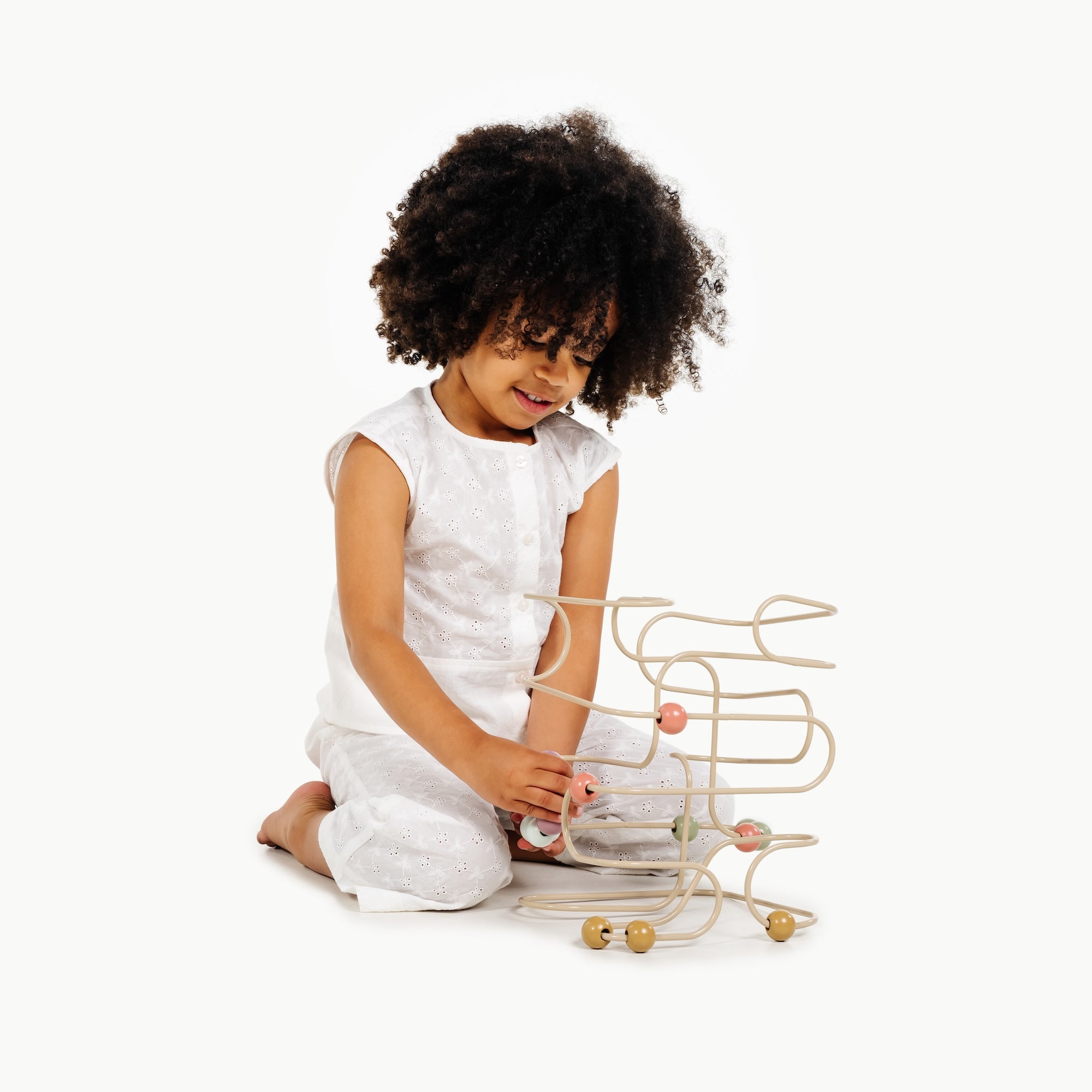 Biscotti / Square@Toddler engaging with bead maze to build hand-eye coordination