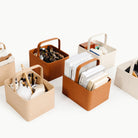 Untanned@Overhead of Large Caddys filled with books, toys, and art supplies 
