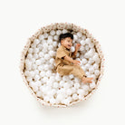 London (on sale)@Child playing in a soft ball pit designed for babies and toddlers