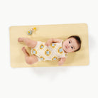 Mellow (on sale)@overhead of baby laying on a micro+ changing mat
