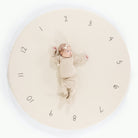 Milestones (on sale)@Overhead of baby laying on padded midi circle